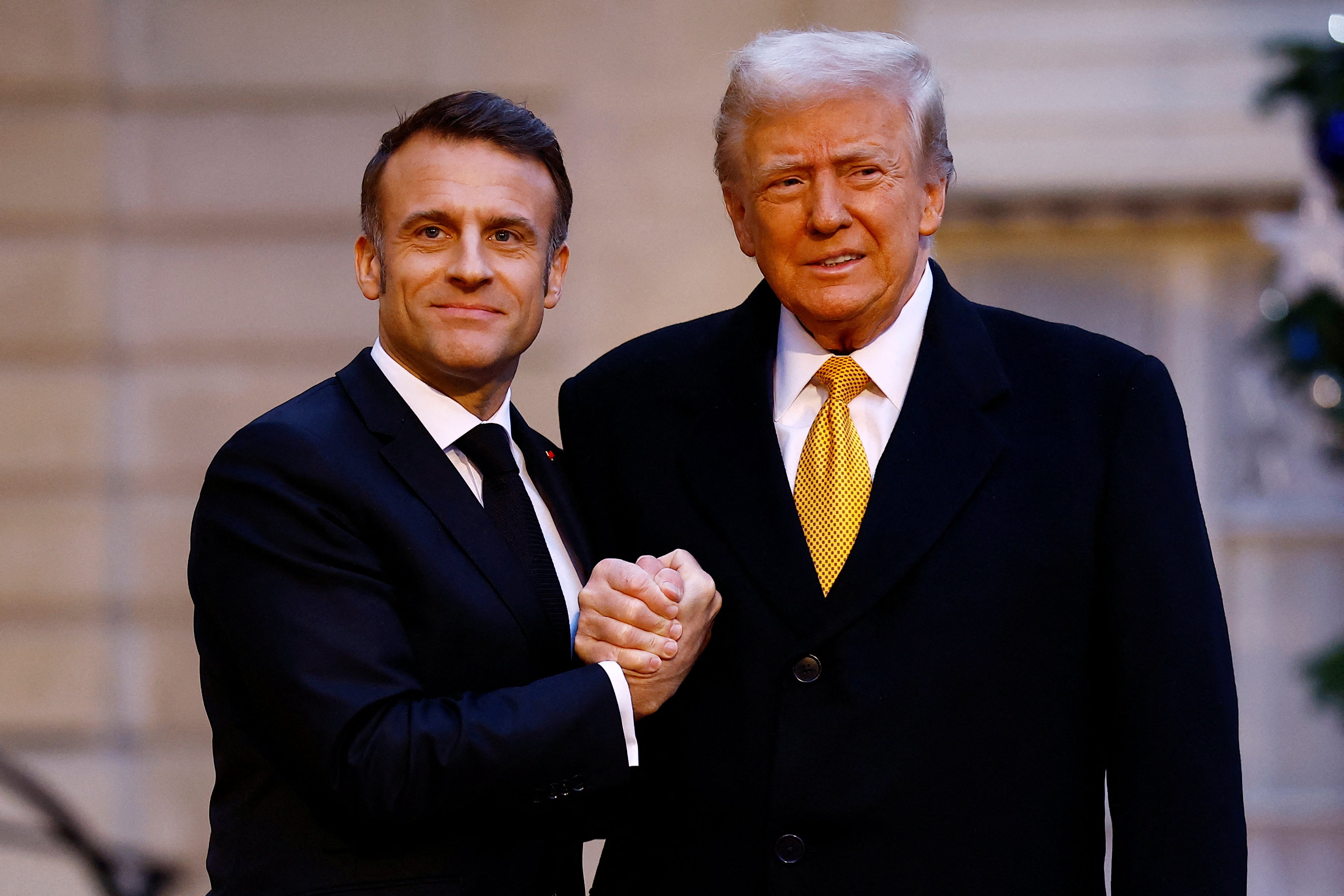 Macron and Trump maintained their handshake for a few seconds while posing for photos