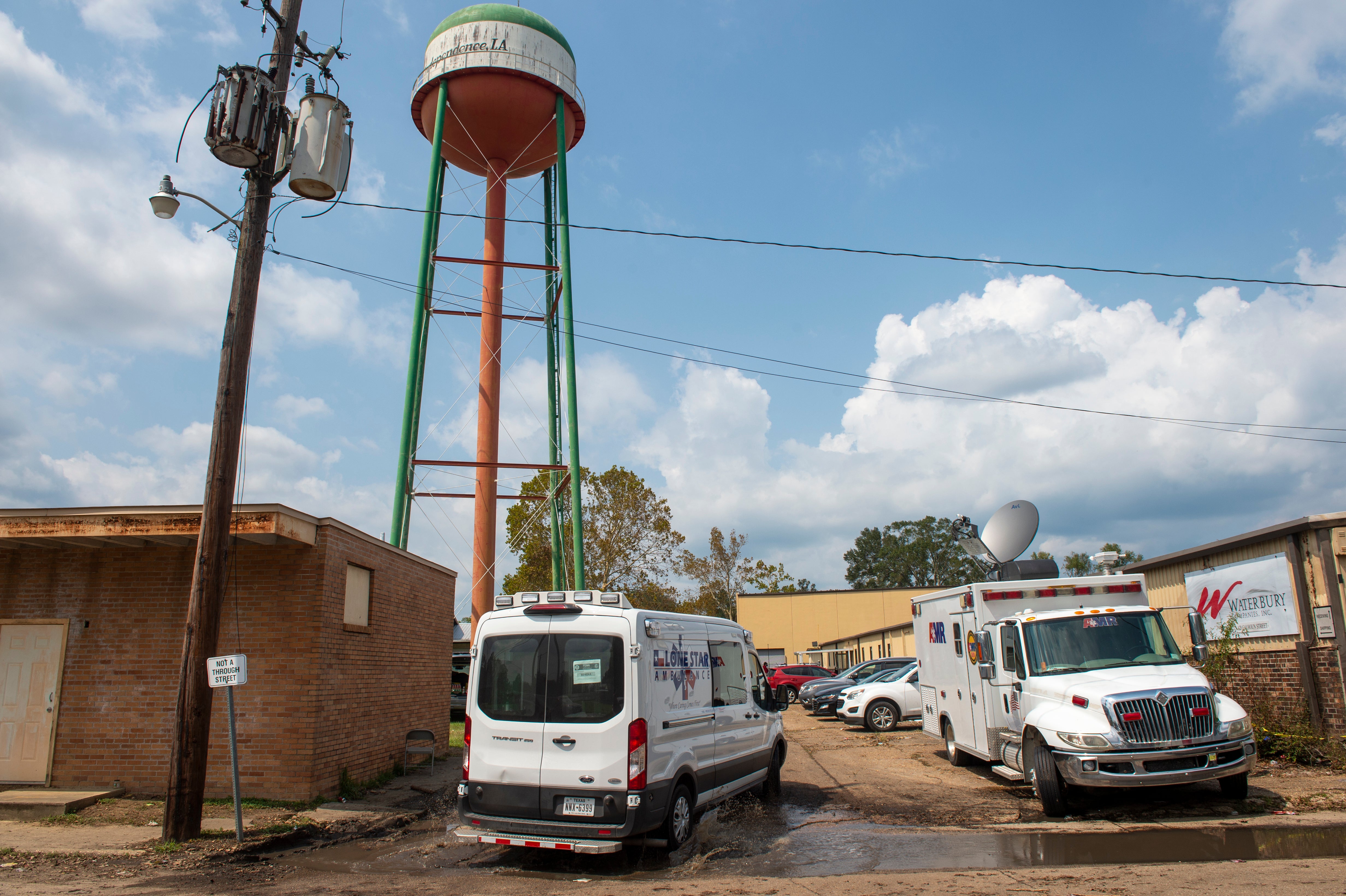 Emergency personnel arrive to evacuate people at a mass shelter, Sept. 2, 2021, in Independence, La.