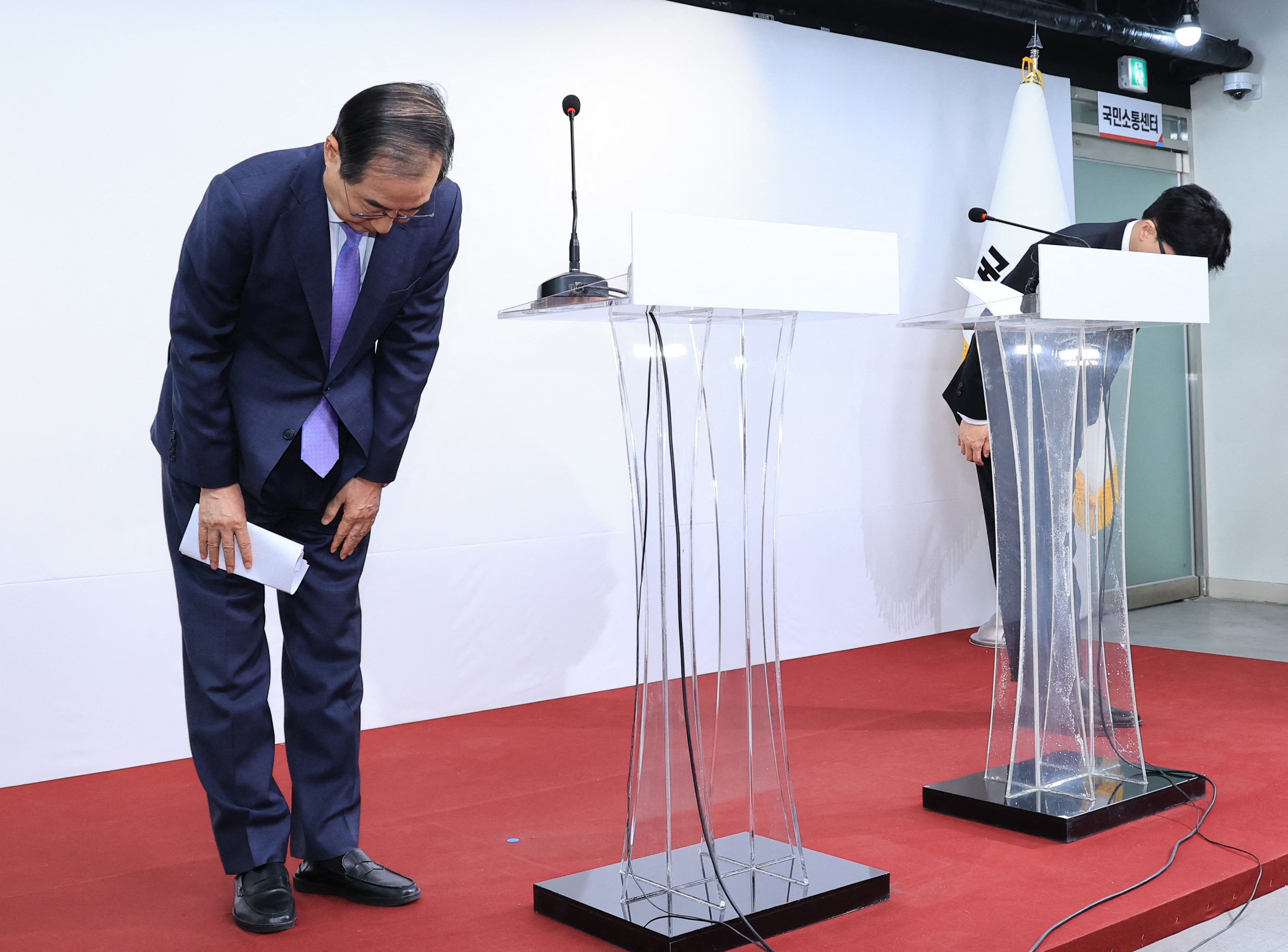 South Korea prime minister Han Duck Soo (left) and People Power Party leader Han Dong Hoon bow during a press conference in Seoul on Sunday