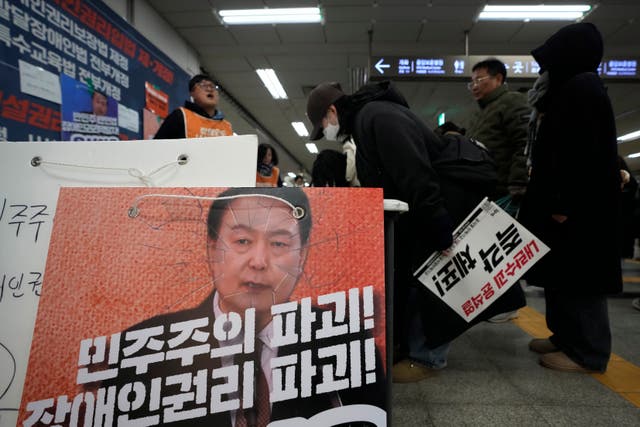 <p>At a Seoul subway station, people sign a petition demanding  impeachment</p>