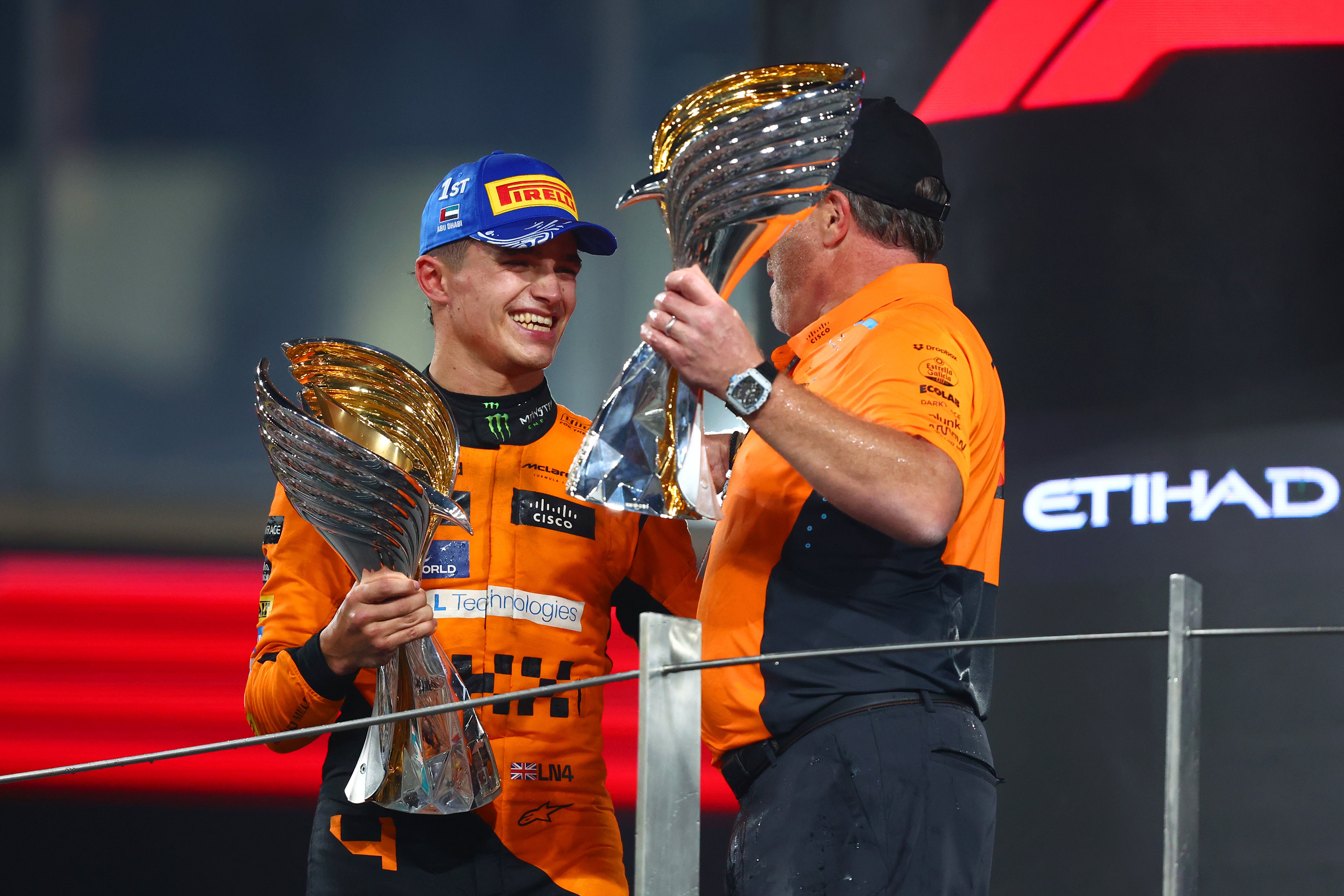 Norris celebrates winning the constructors’ title with McLaren CEO Zak Brown in Abu Dhabi