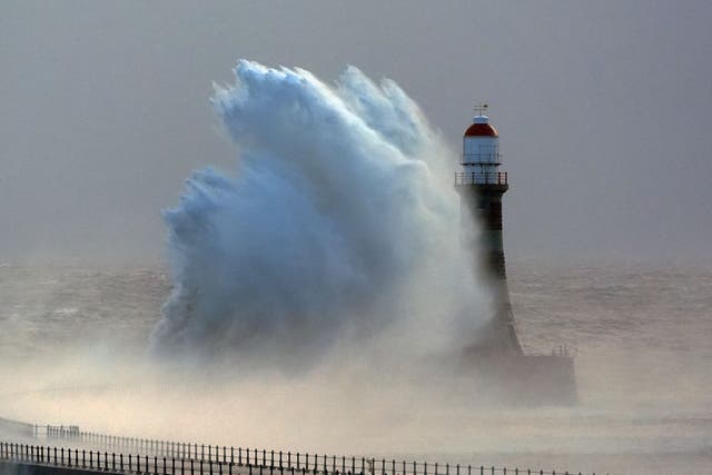 Rough seas at the Roker lighthouse in Sunderland, after Storm Darragh hit the UK and Ireland (Owen Humphreys/PA)