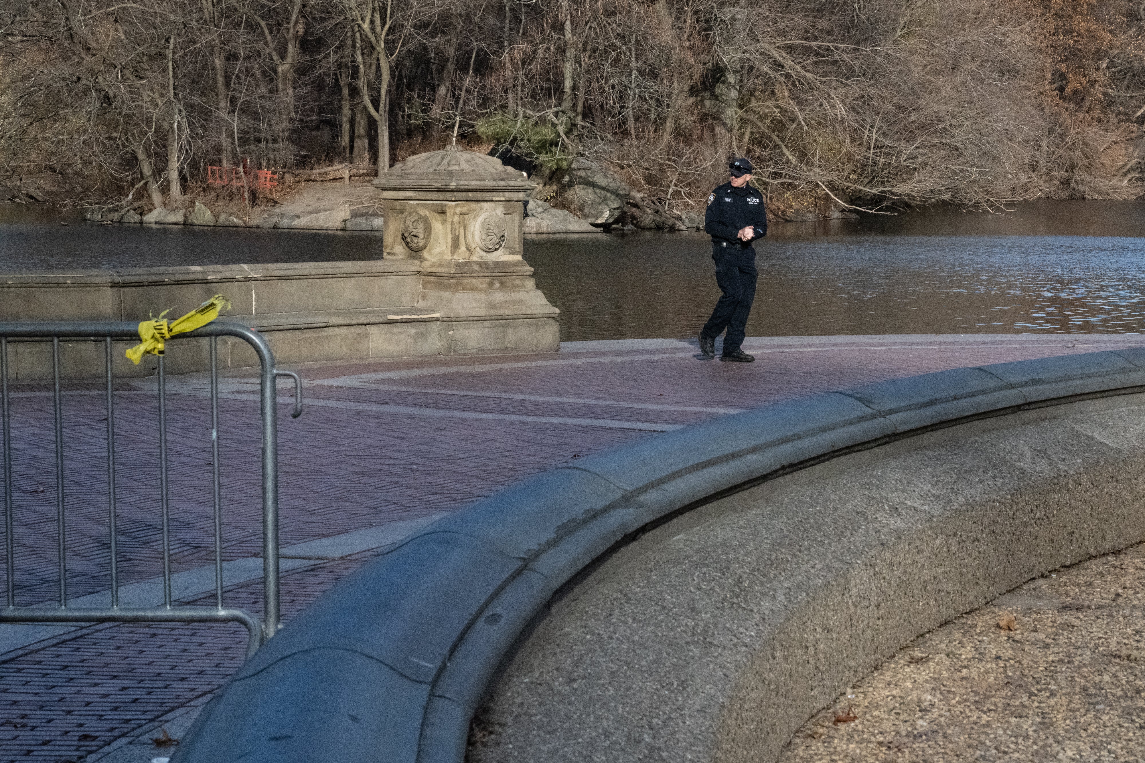 A New York police officer patrols the pond near Bethesda Fountain in Central Park where divers searched for the gun used by the man who killed UnitedHealthcare CEO Brian Thompson