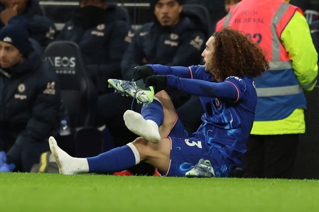 <p>Marc Cucurella switches boots on the side of the pitch</p>