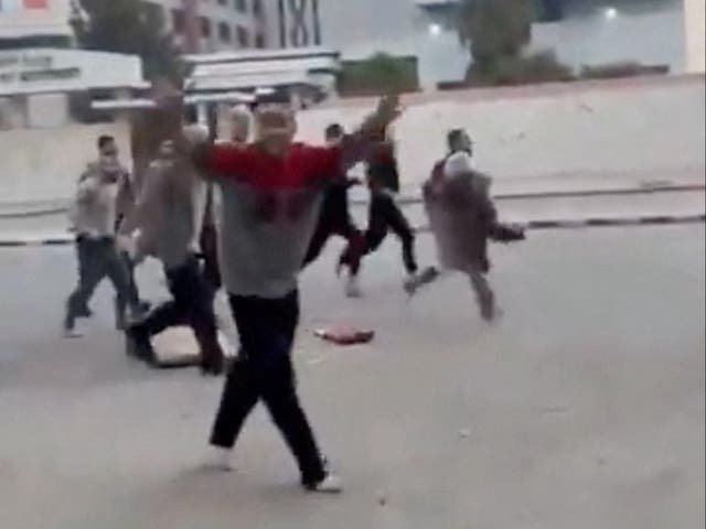 <p>A person gestures as individuals, reportedly freed prisoners, run in the streets of Damascus, Syria</p>