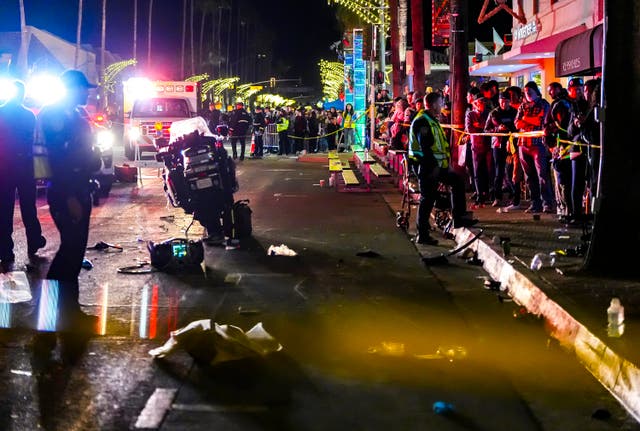 <p>Emergency crews treat patients after a Palm Springs Police motorcycle crashes into the crowd of spectators on North Palm Canyon Drive during the Festival of Lights Parade in Palm Springs, Calif., Saturday, Dec. 7, 2024</p>