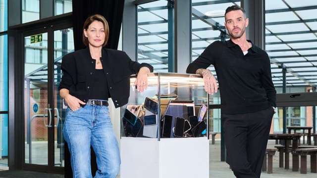 <p>Emma and Matt Willis next to the glass box where all the social experiment participants’ phones and iPads were locked </p>