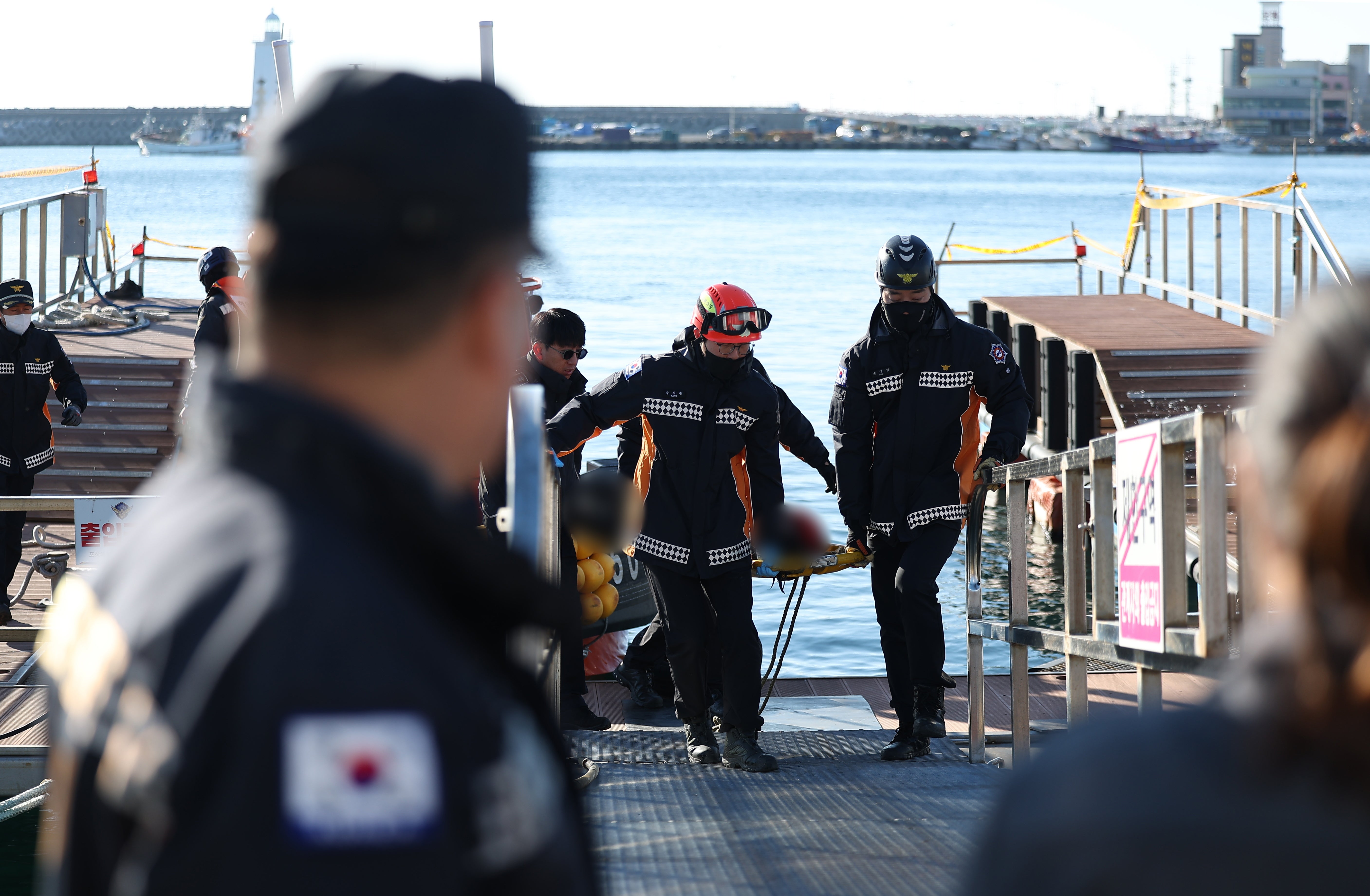 File image: The Korea Coast Guard (KCG) moves a crew member rescued from a capsized fishing boat earlier in December at Gampo Port in Gyeongju, South Korea