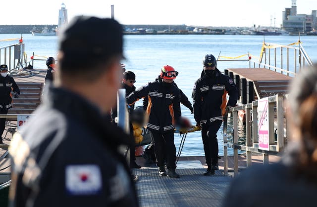 <p>File image: The Korea Coast Guard (KCG) moves a crew member rescued from a capsized fishing boat earlier in December at Gampo Port in Gyeongju, South Korea</p>