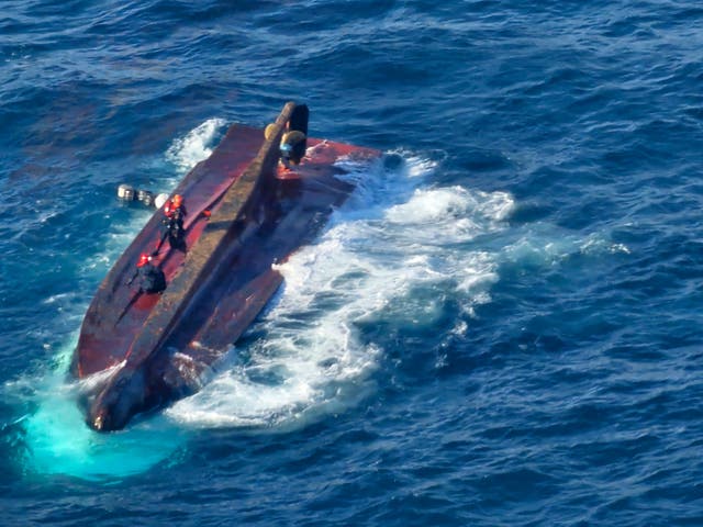 <p>Members of South Korean coast guard conduct a search and rescue operation from a capsized boat in waters off Gyeongju, South Korea</p>