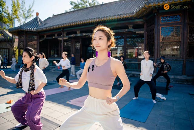 <p>Ding Dong, a finance professional, participates in a yoga group</p>