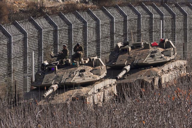 <p>Israeli soldiers sit on top of a tank along the so-called Alpha Line that separates the Israeli-annexed Golan Heights from Syria proper </p>