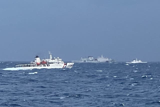 <p>A Chinese coast guard ship sails past Taiwanese vessels in east of the island</p>