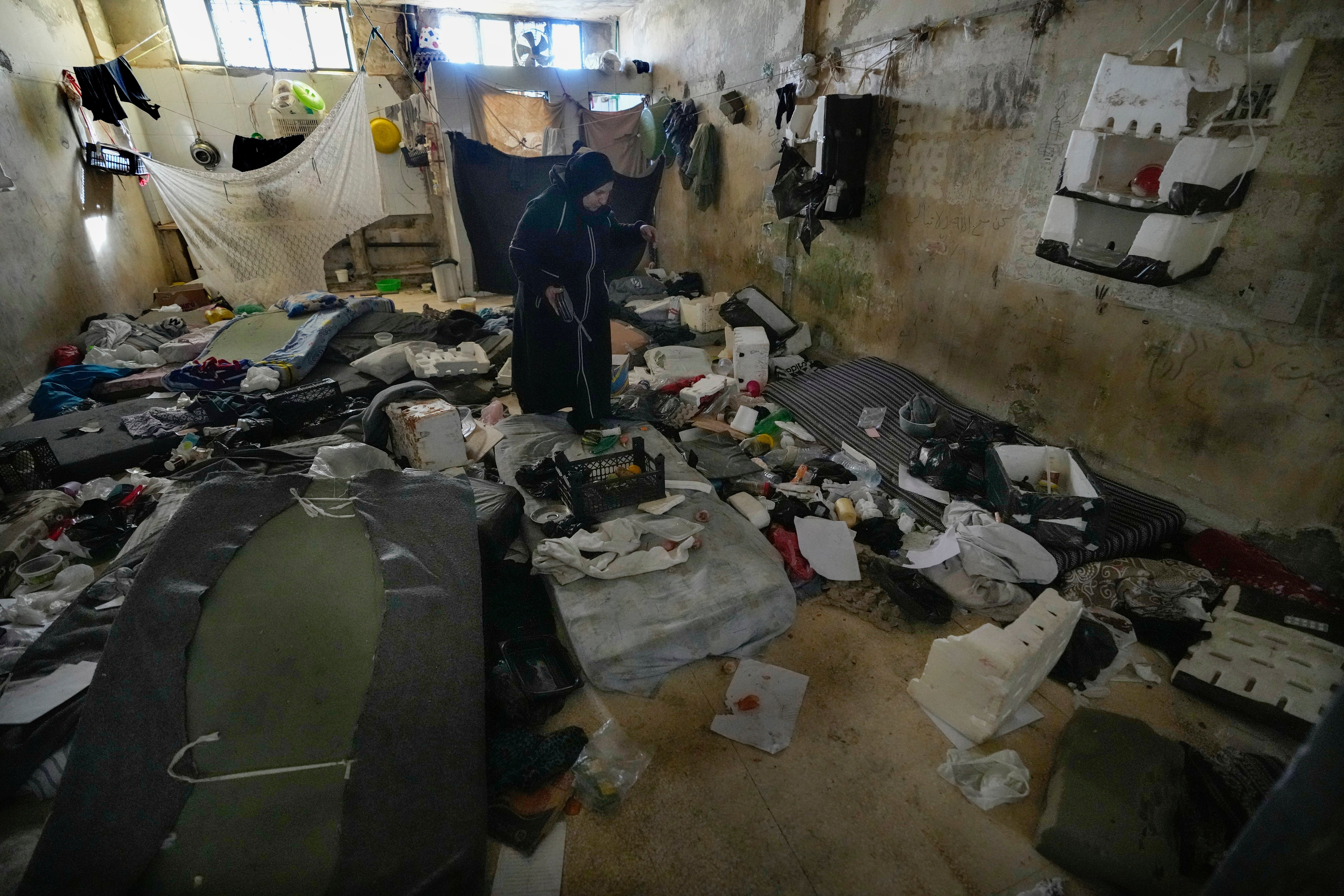 A woman looks at a room of the infamous Saydnaya military prison, just north of Damascus