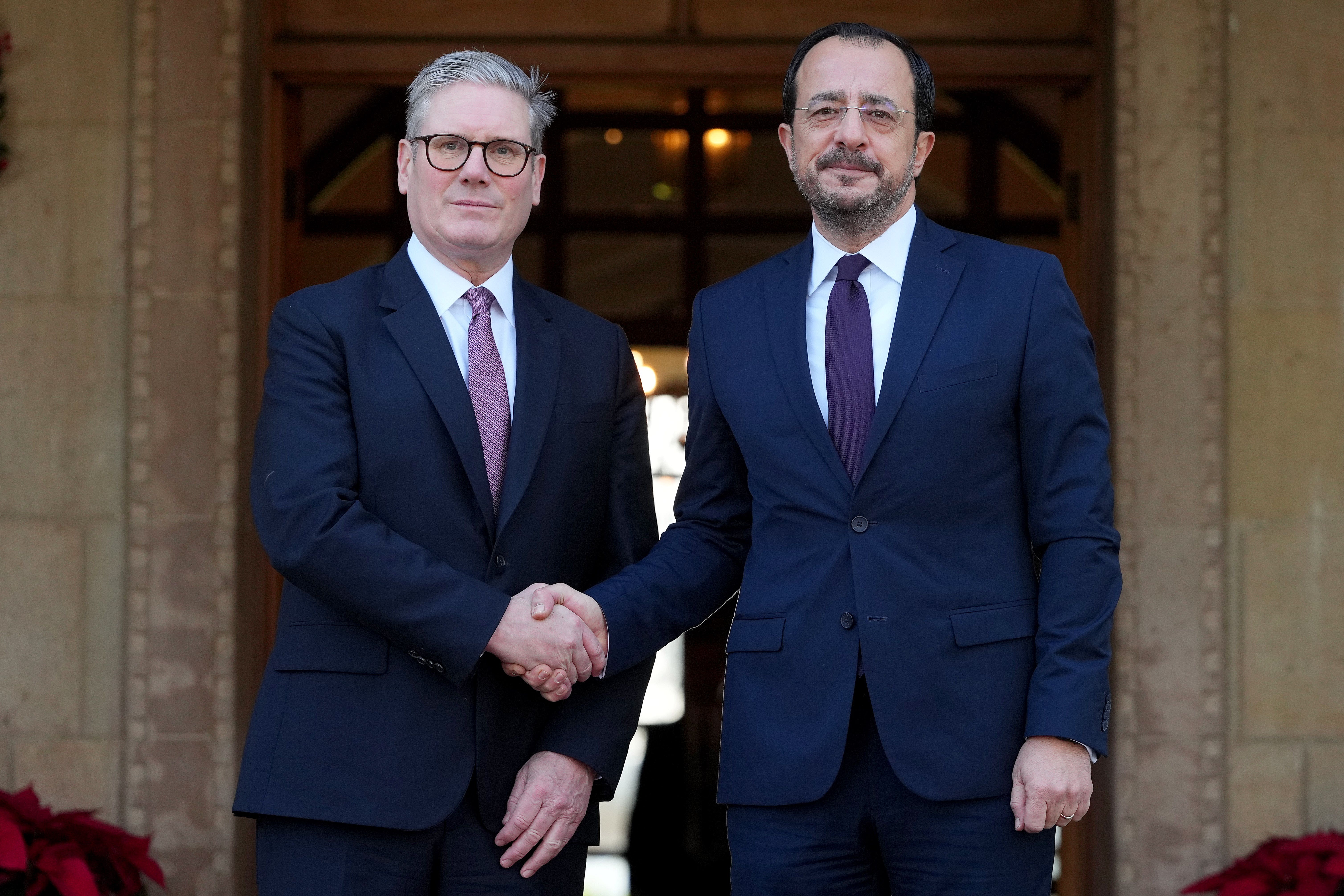 Sir Keir Starmer is welcomed by Cyprus’ President Nikos Christodoulides in Nicosia (Kirsty Wigglesworth/PA)