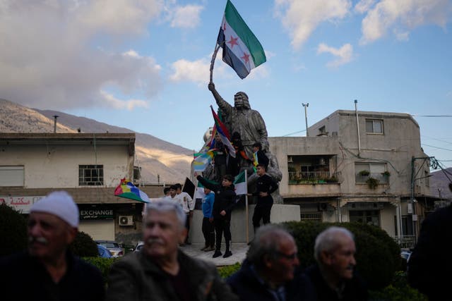 People attend a rally celebrating the fall of Syrian President Bashar Assad’s government (Matias Delacroix/AP)