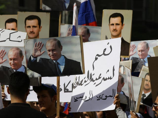 <p>Several hundred people gather near the Russian embassy in Damascus in 2015 </p>