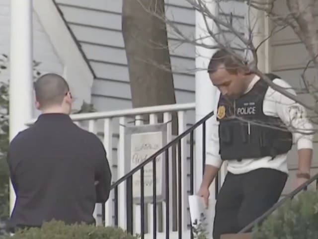 <p>A police officer in Chevy Chase, Maryland exits the house where 37-year-old Mackenzie Colgan allegedly drowned her 3-month old daughter in a bathtub on December 8, 2024</p>