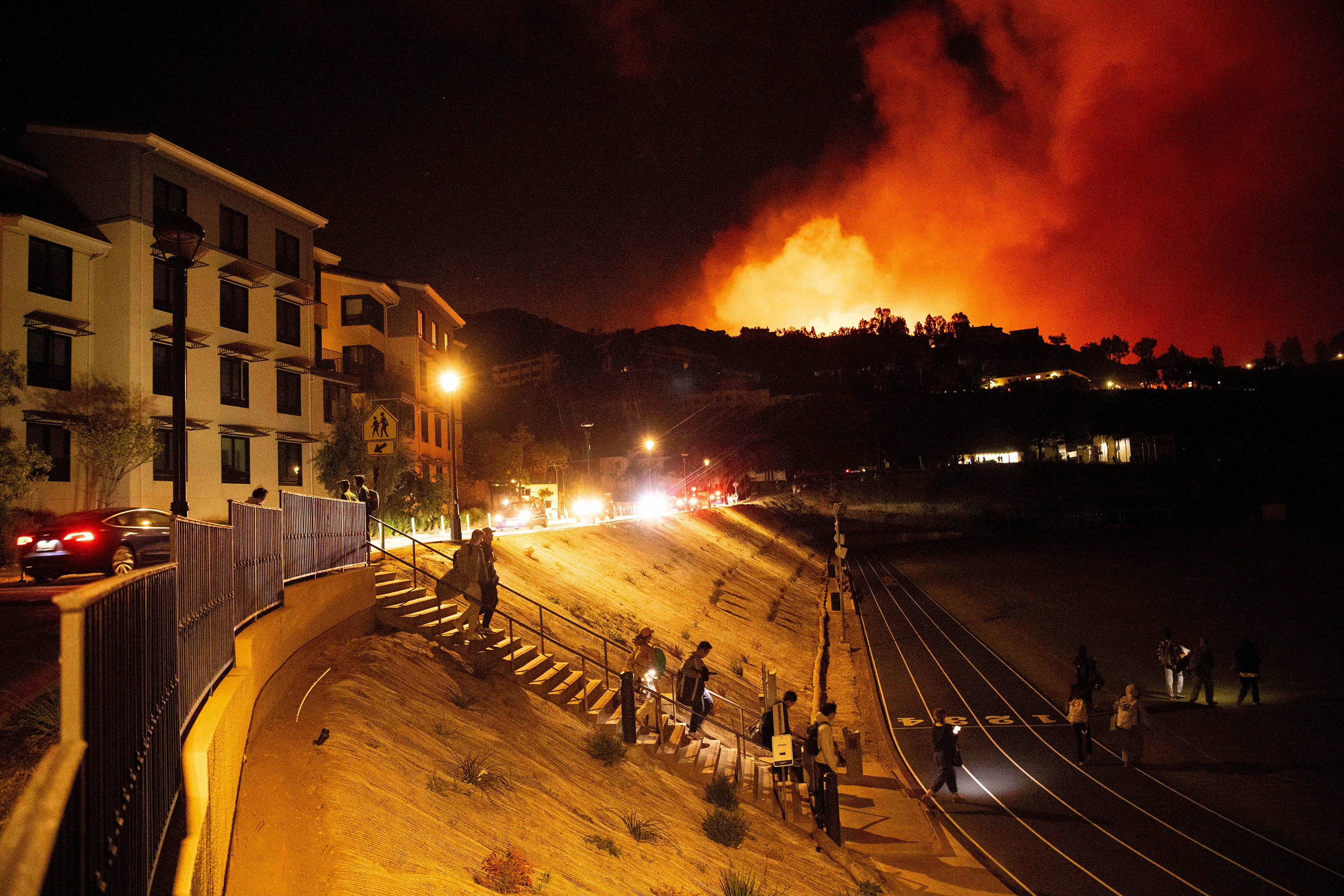 Students evacuate from Pepperdine University on Tuesday as the Franklin Fire burns in Malibu, California. Dangerous weather was expected to continue through Wednesday