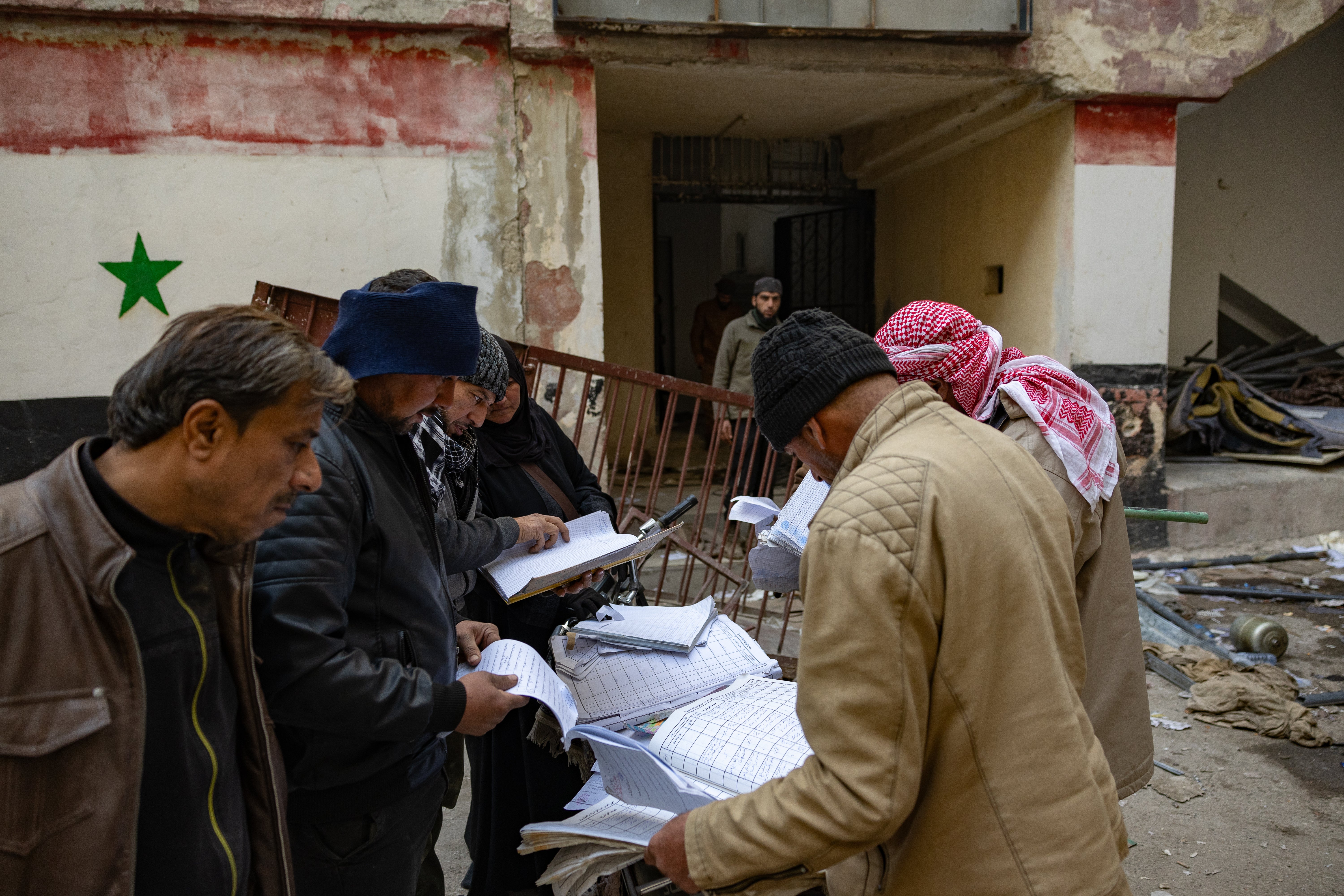 Outside the notorious Sednaya prison near Damascus, relatives search records to find out what happened to their loved ones