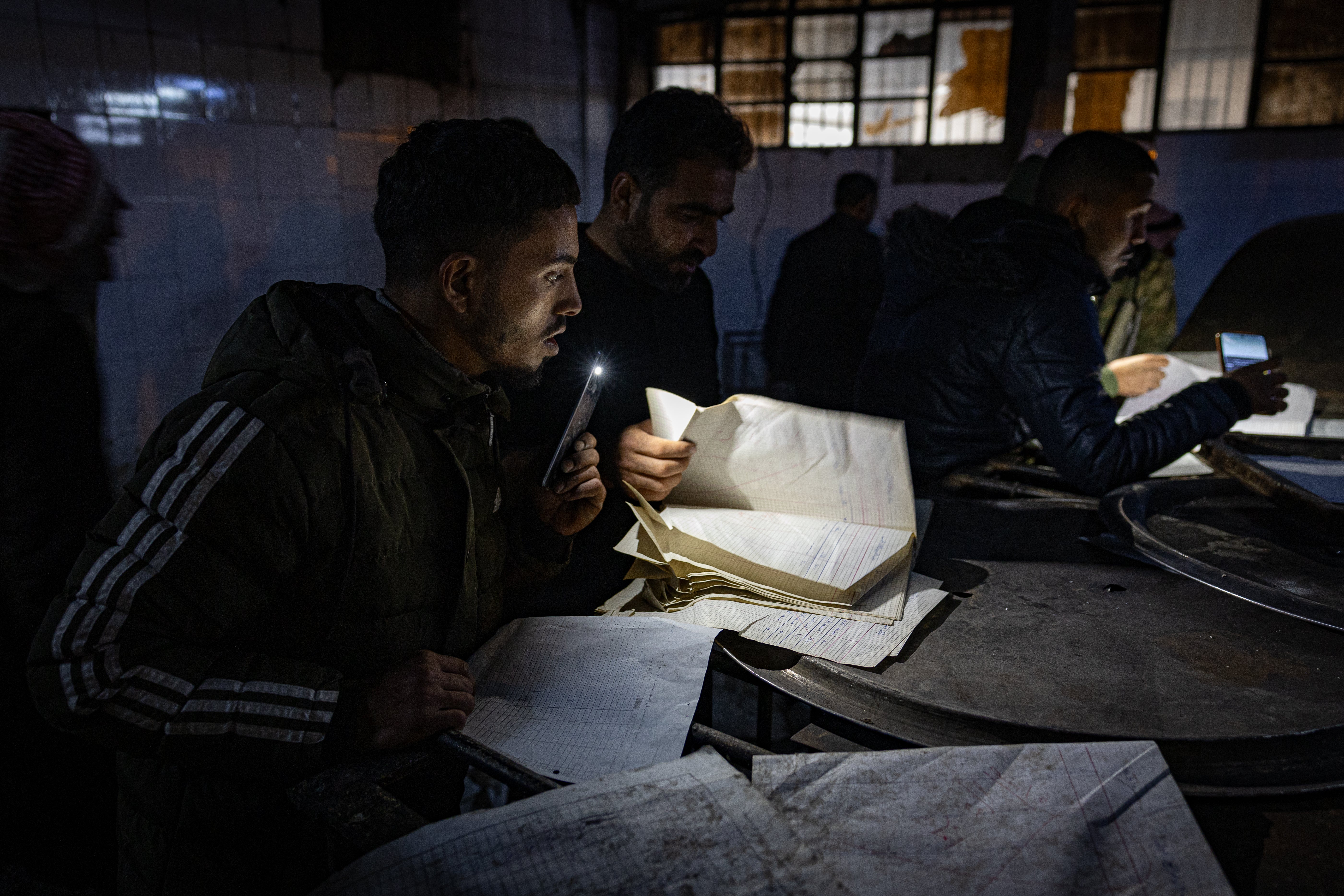 Relatives search records at the notorious Sednaya prison in Damascus for signs of missing loved ones