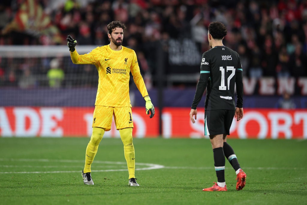 Alisson Becker of Liverpool talks to teammate Curtis Jones