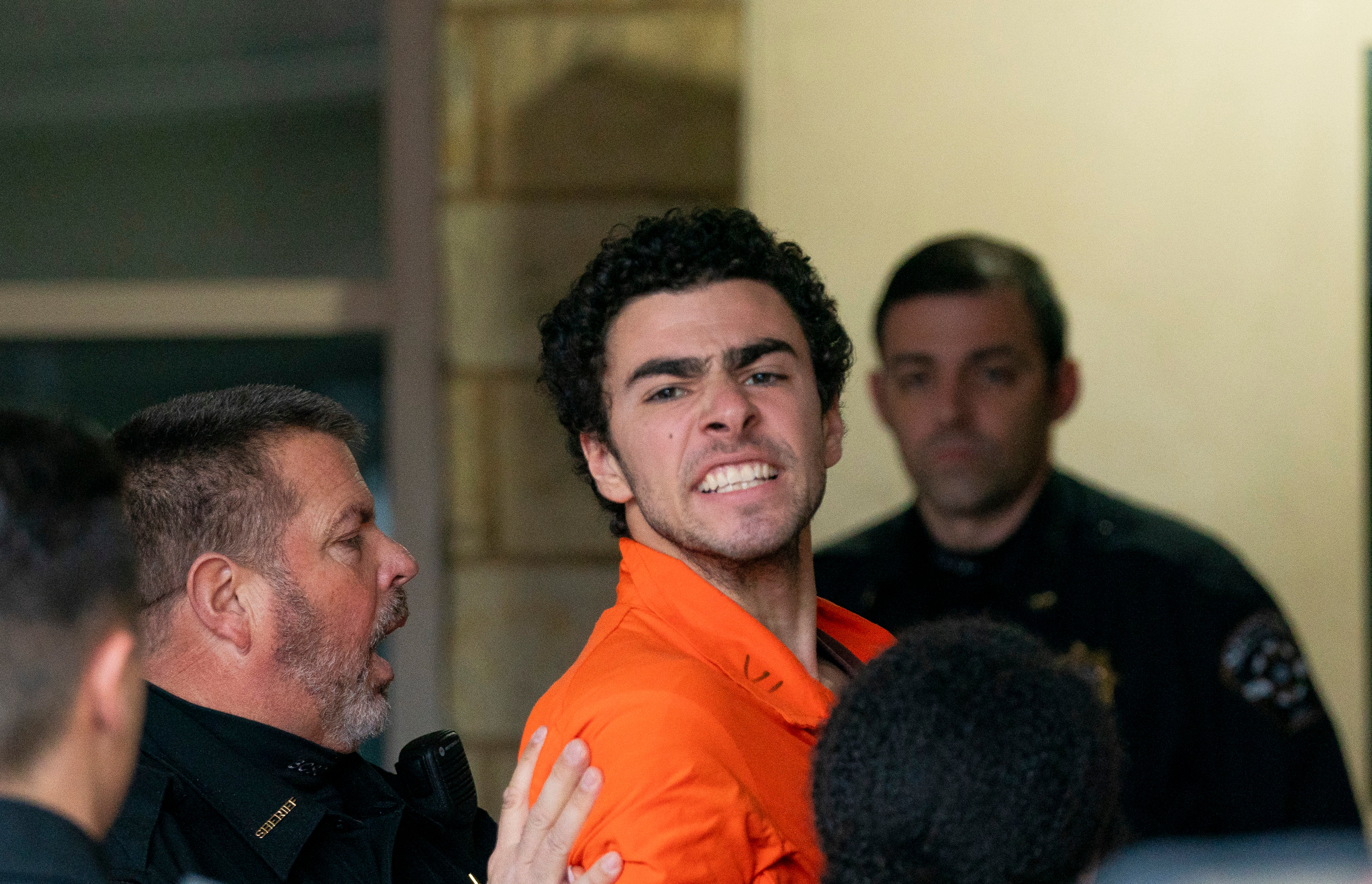 Luigi Mangione seen being taken into the Blair County Courthouse on Tuesday