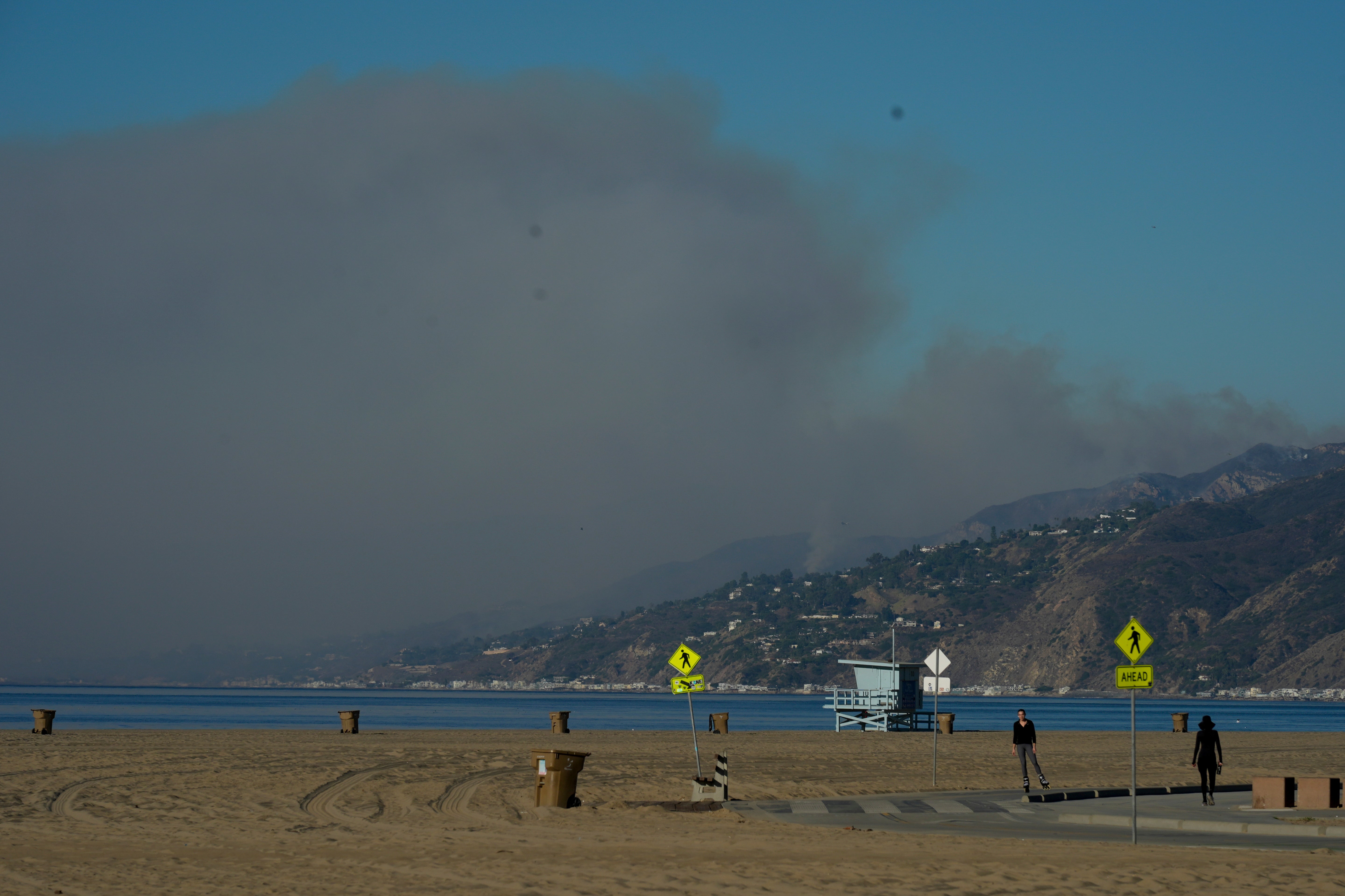 A plume of smoke from the Franklin Fire rises over the ocean on Tuesday in Malibu, California. The fire has continued to spread in windy conditions