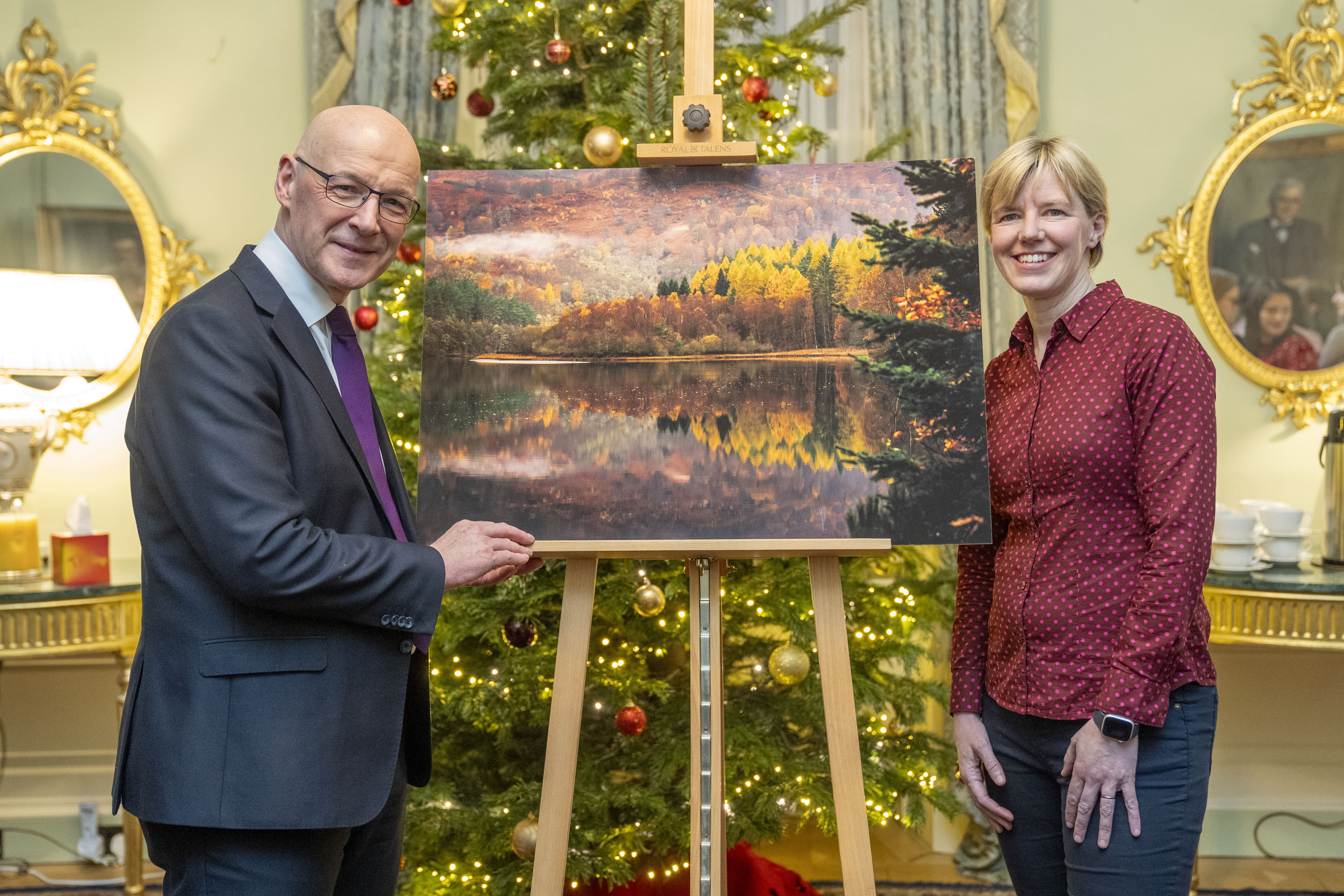 First Minister John Swinney and PA news agency photographer Jane Barlow at the launch of the First Minister’s official Christmas card at Bute House in Edinburgh (Lesley Martin/PA)