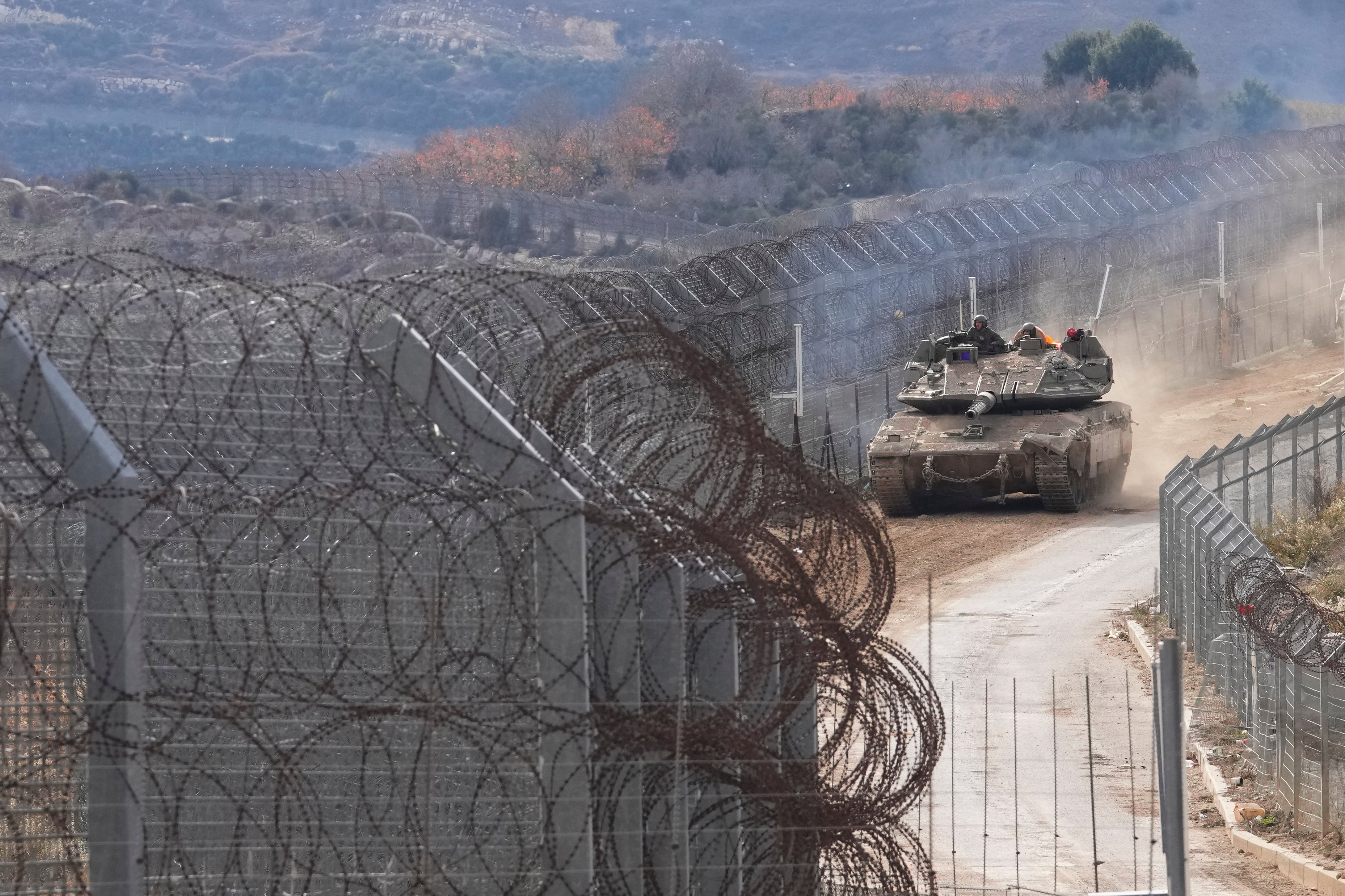 An Israeli army tank maneuvers near the so-called Alpha Line that separates the Israeli-annexed Golan Heights from Syria