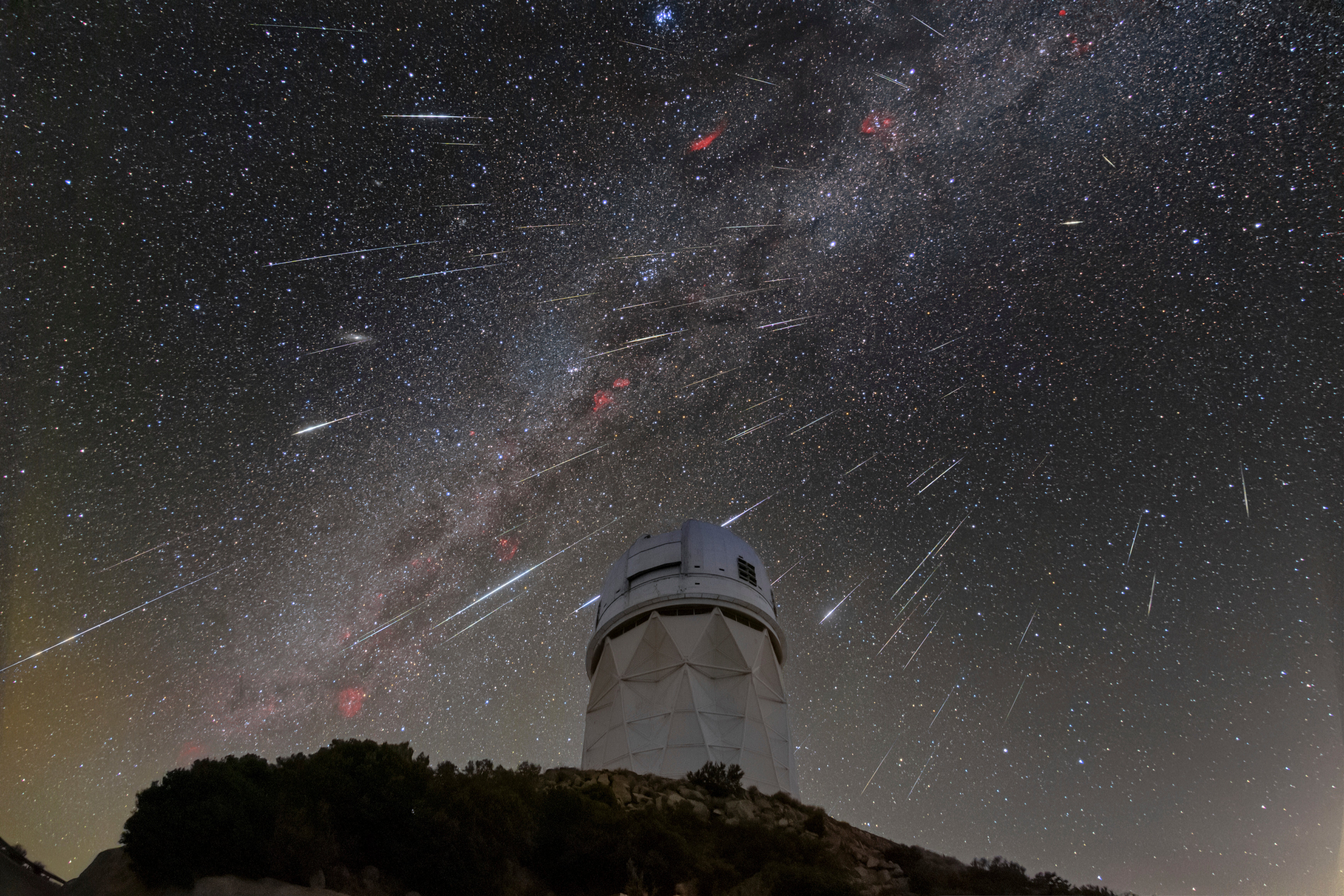 Meteors from the Geminid meteor shower streak across the sky above the Nicholas U