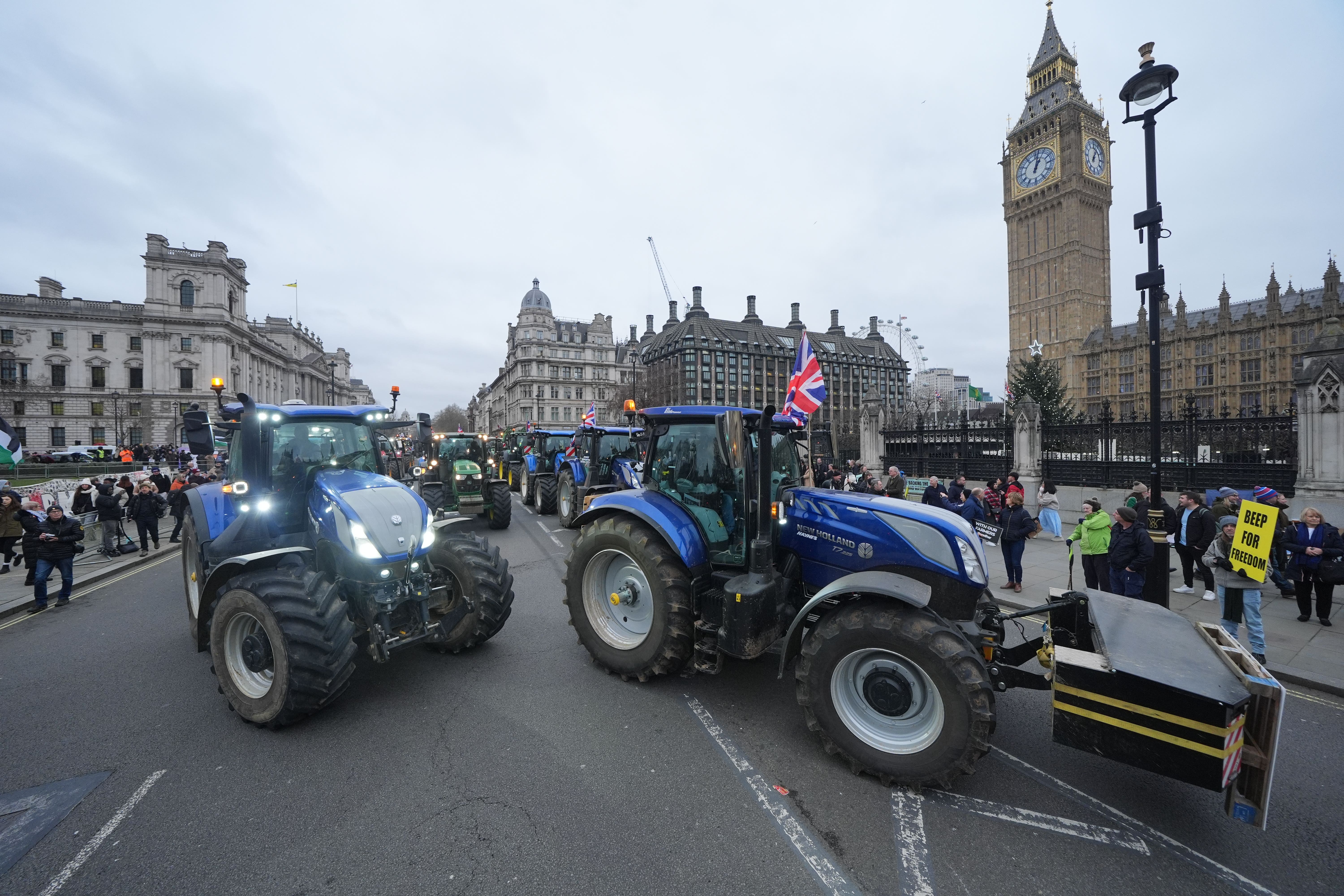 Tractors lined up outside the Houses of Parliament in Westminster for the protest (Yui Mok/PA)