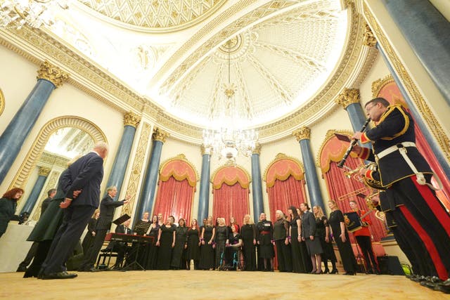 The Military Wives Choir, conducted by Hilary Davan Wetton, performs their latest single for the King and Queen (Yui Mok/PA)