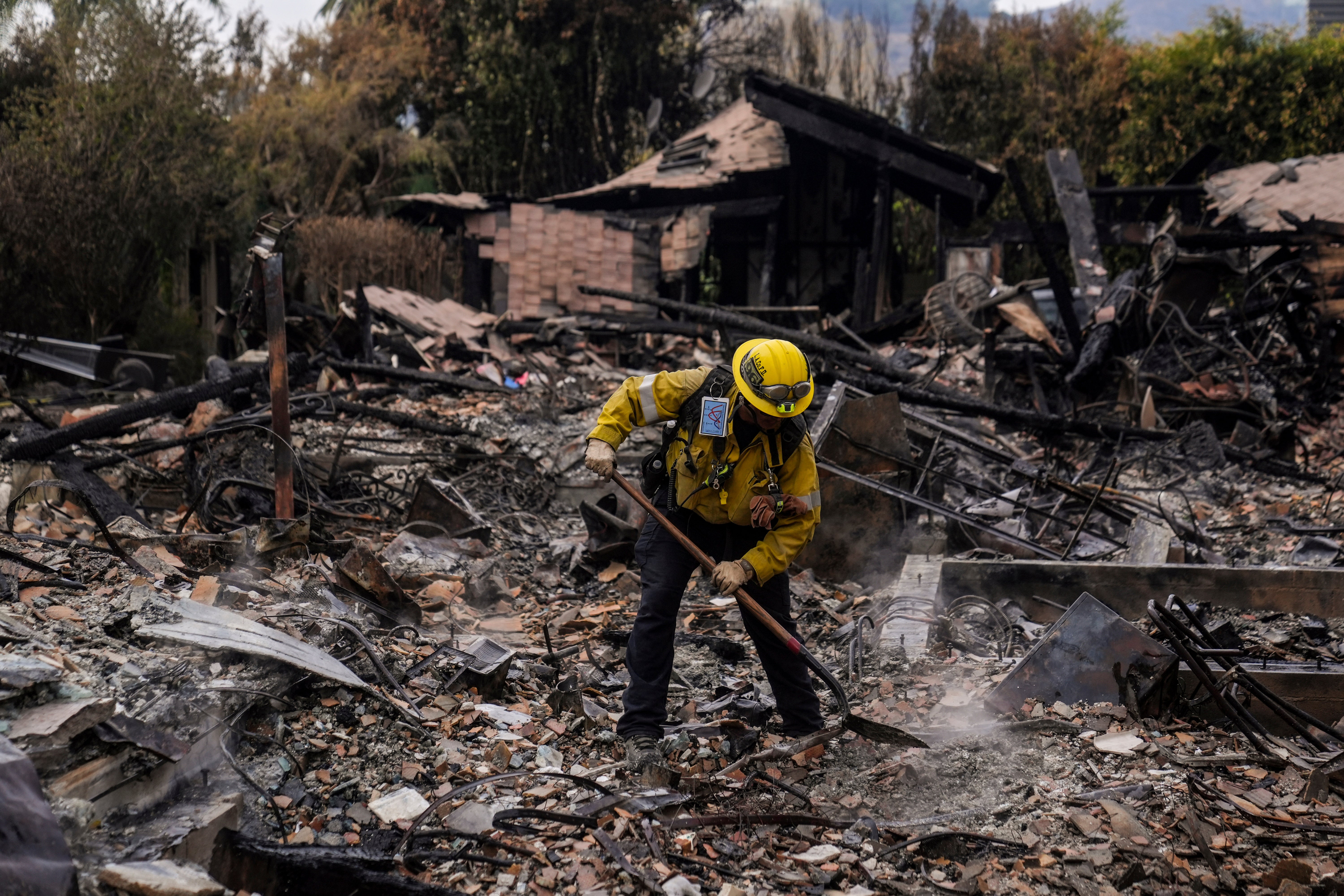 A firefighter works at a home devastated by the Franklin Fire in Malibu, California, on Wednesday. Multiple homes were destroyed in the blaze