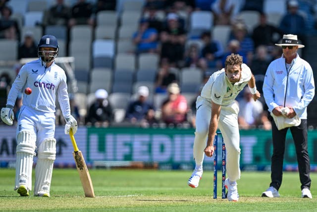 England’s Ben Duckett, left, watches as Tim Southee of New Zealand bowls (Andrew Cornaga/Photosport/AP)