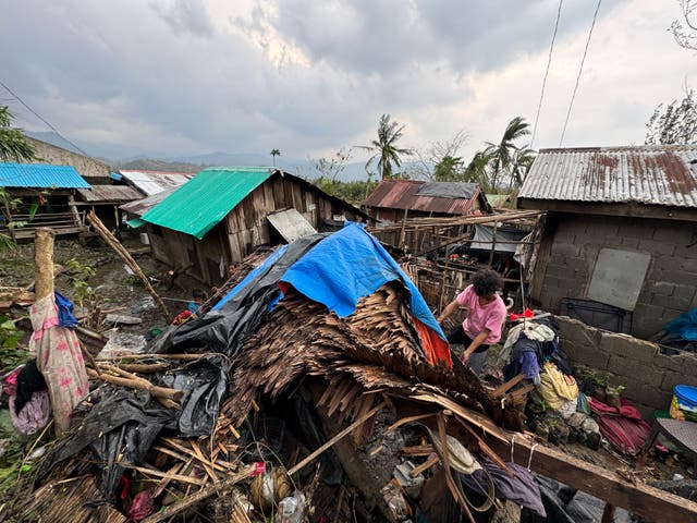 <p>A resident inspects destroyed house in Santa Ana town, Cagayan province, north of Manila on 8 November 2024, following Typhoon Yinxing hitting the province</p>