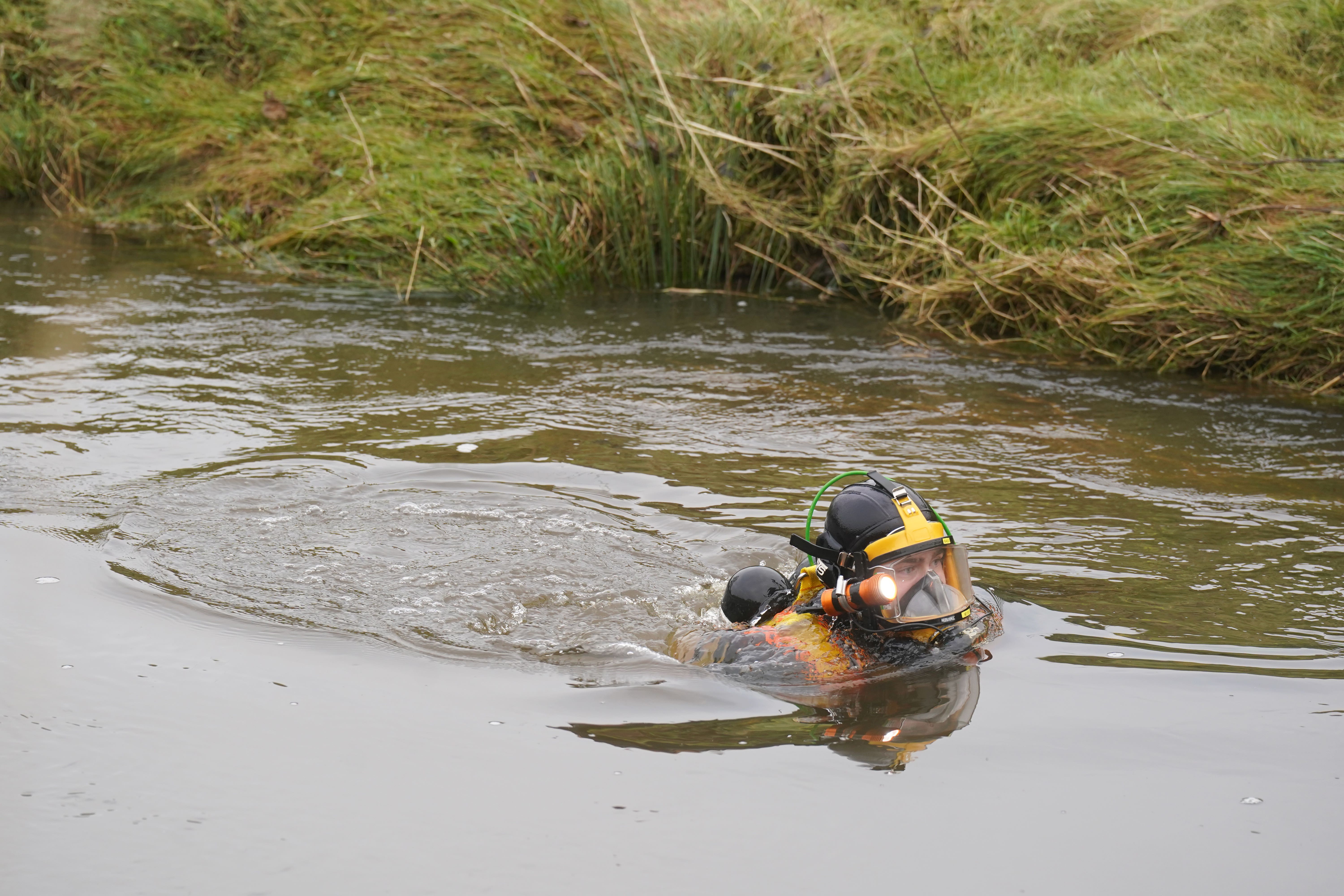 Divers searching the water at Abberwick Ford on the River Aln near Alnwick (Owen Humphreys/PA)