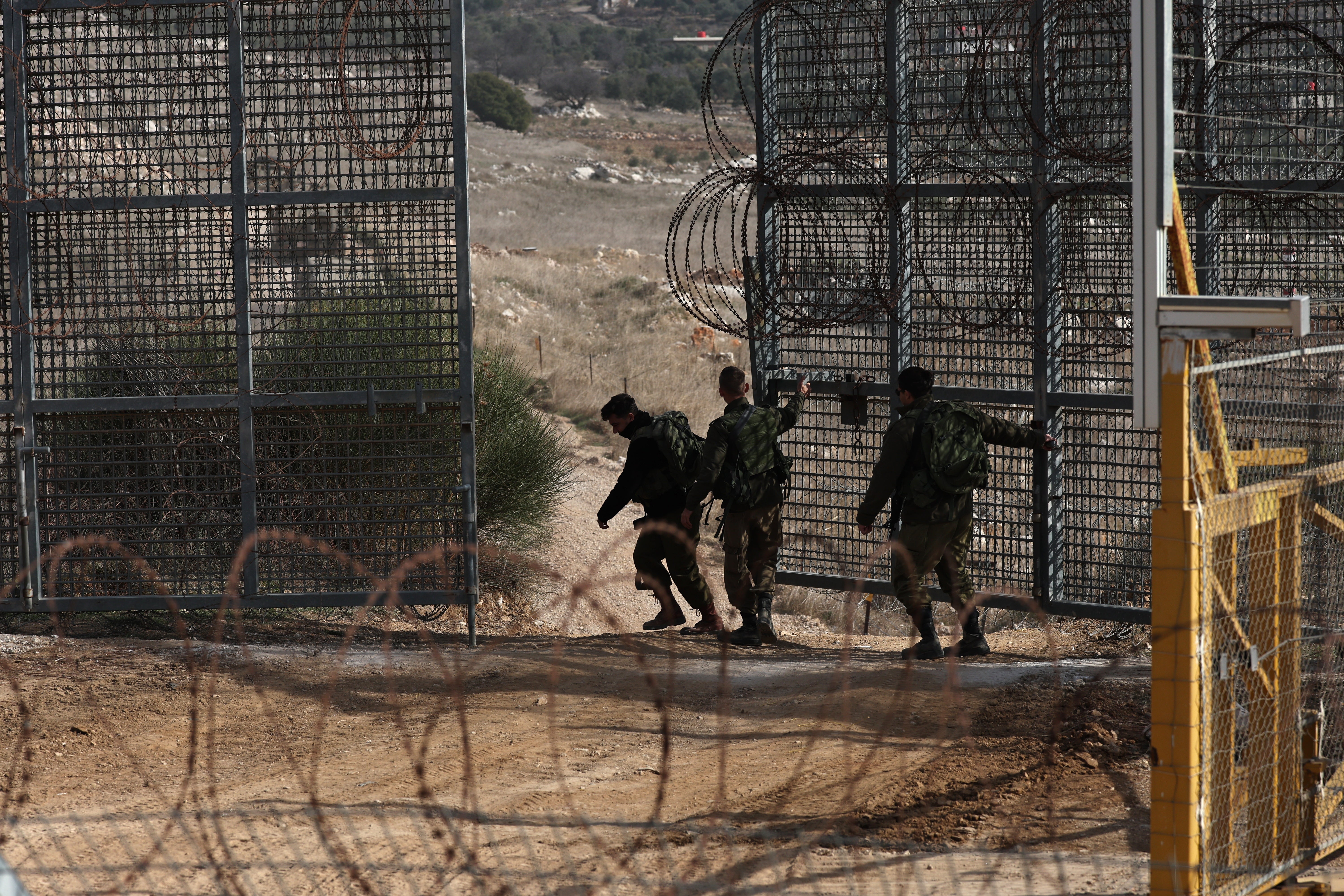 Israeli move a gate in between Israel and Syria, near the Druze village of Majdal Shams, in the Israeli-annexed Golan Heights