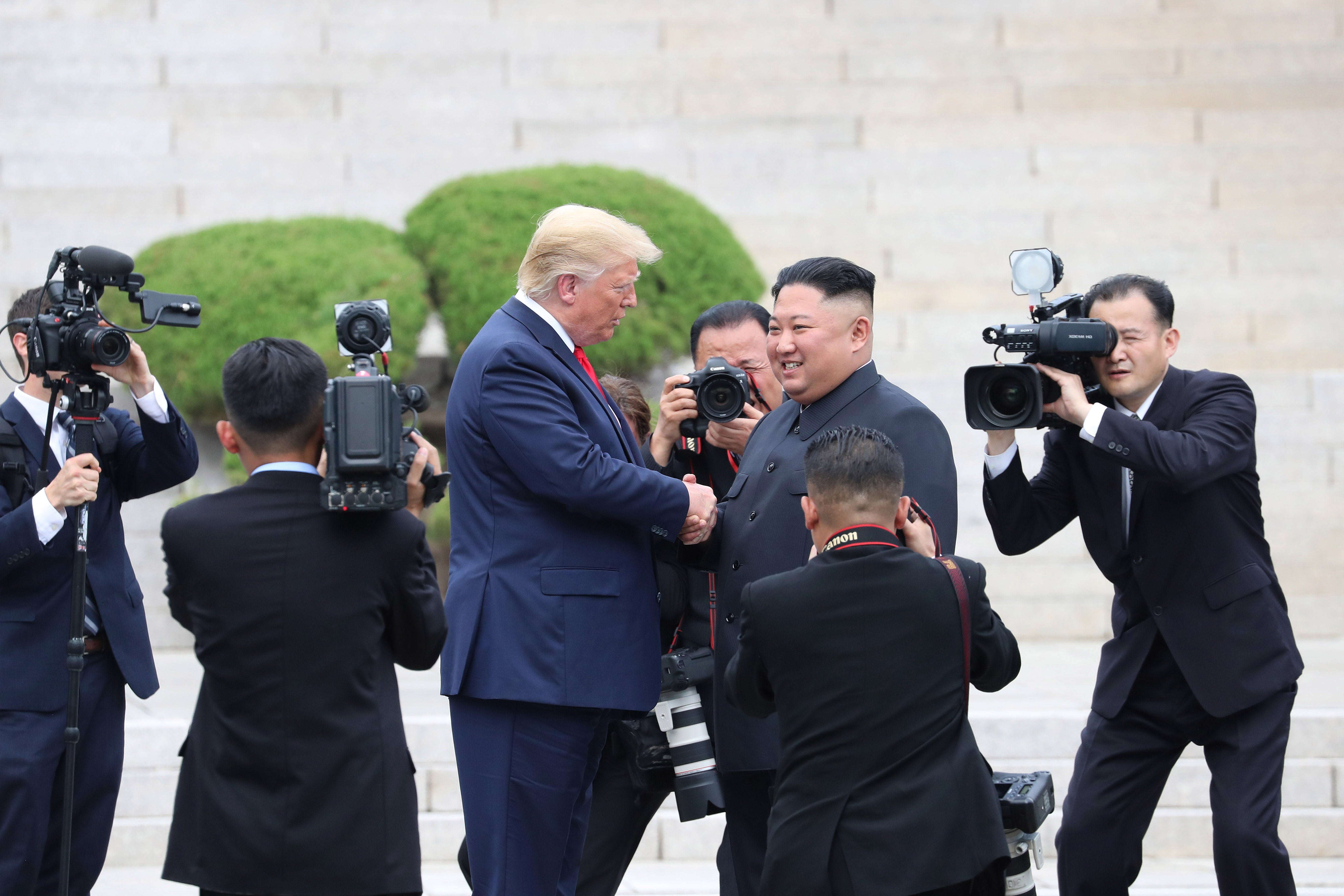 Kim Jong Un and Donald Trump inside the demilitarized zone separating the Koreas on 30 June 2019