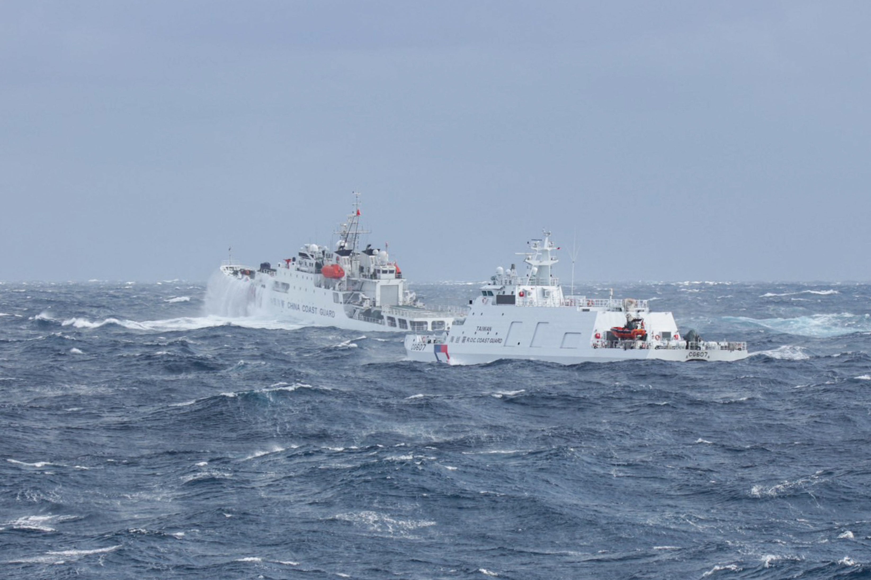 A Taiwanese coast guard ship (R) monitoring a Chinese coast guard ship