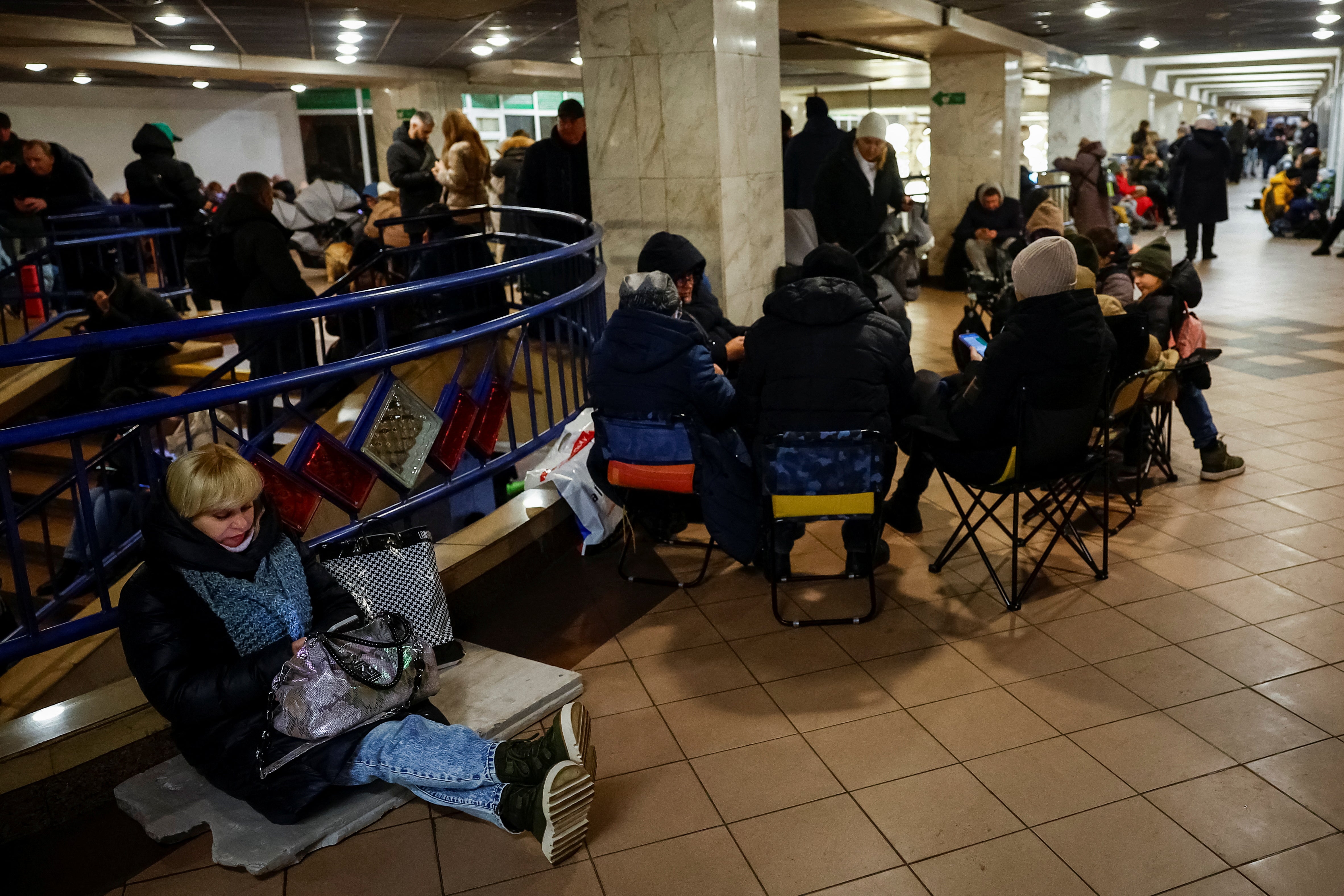 People take shelter inside a metro station during a Russian military strike in Kyiv, Ukraine