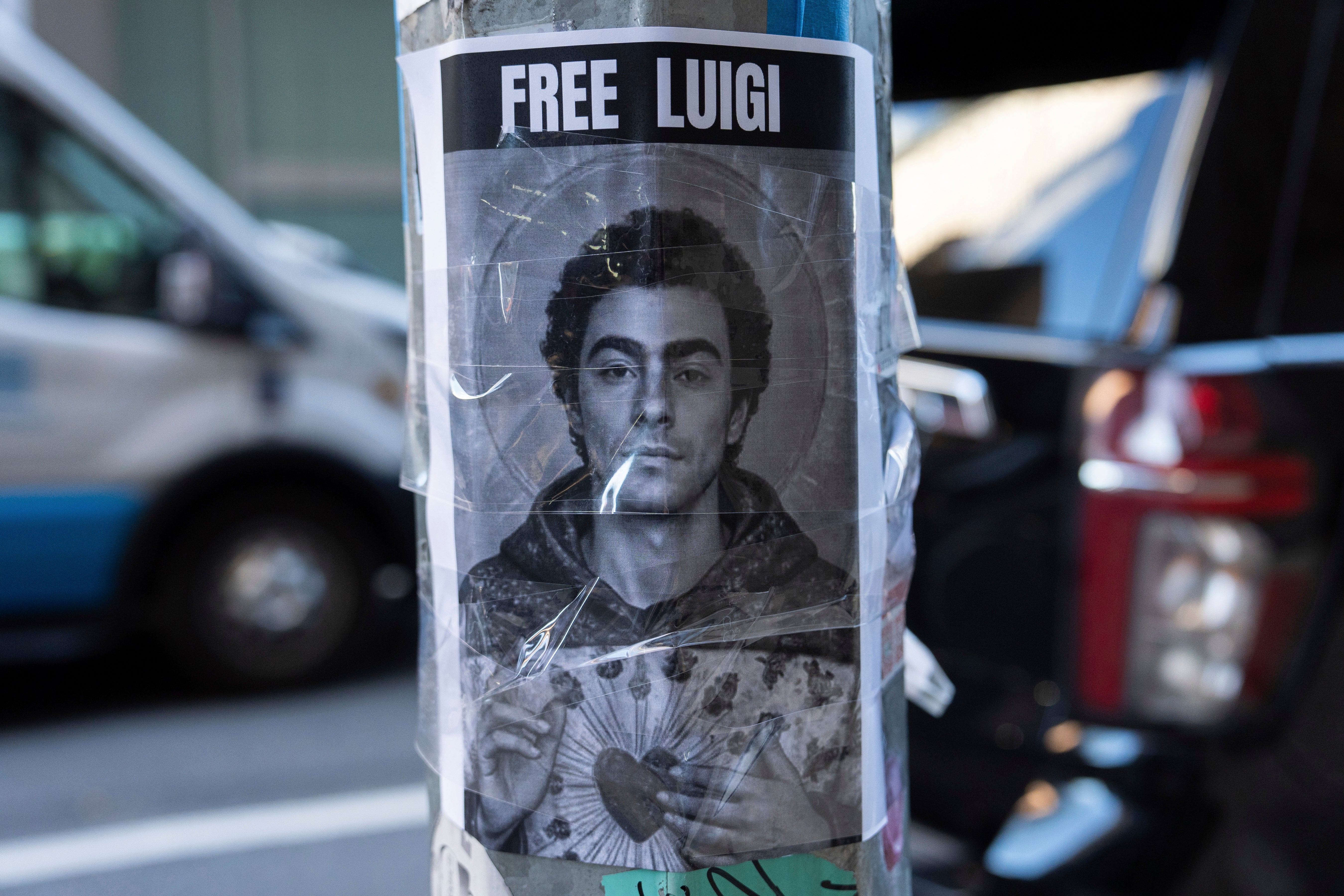 A poster depicting Luigi Mangione hangs outside the New York Hilton Midtown hotel on Thursday