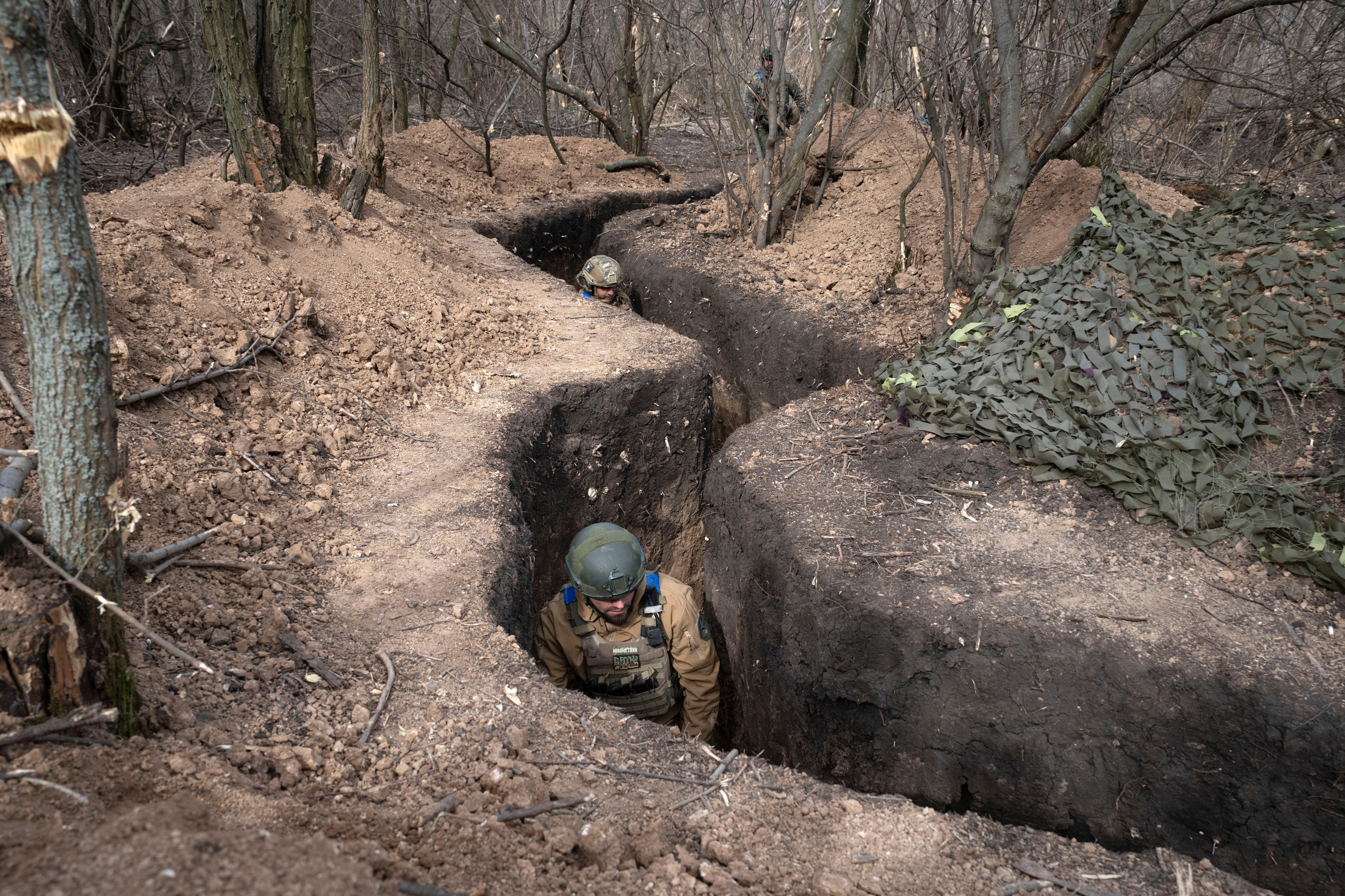 Ukrainian servicemen of the 28th Separate Mechanised Brigade take their position in a trench at the front line, near Bakhmut, Donetsk region, Ukraine