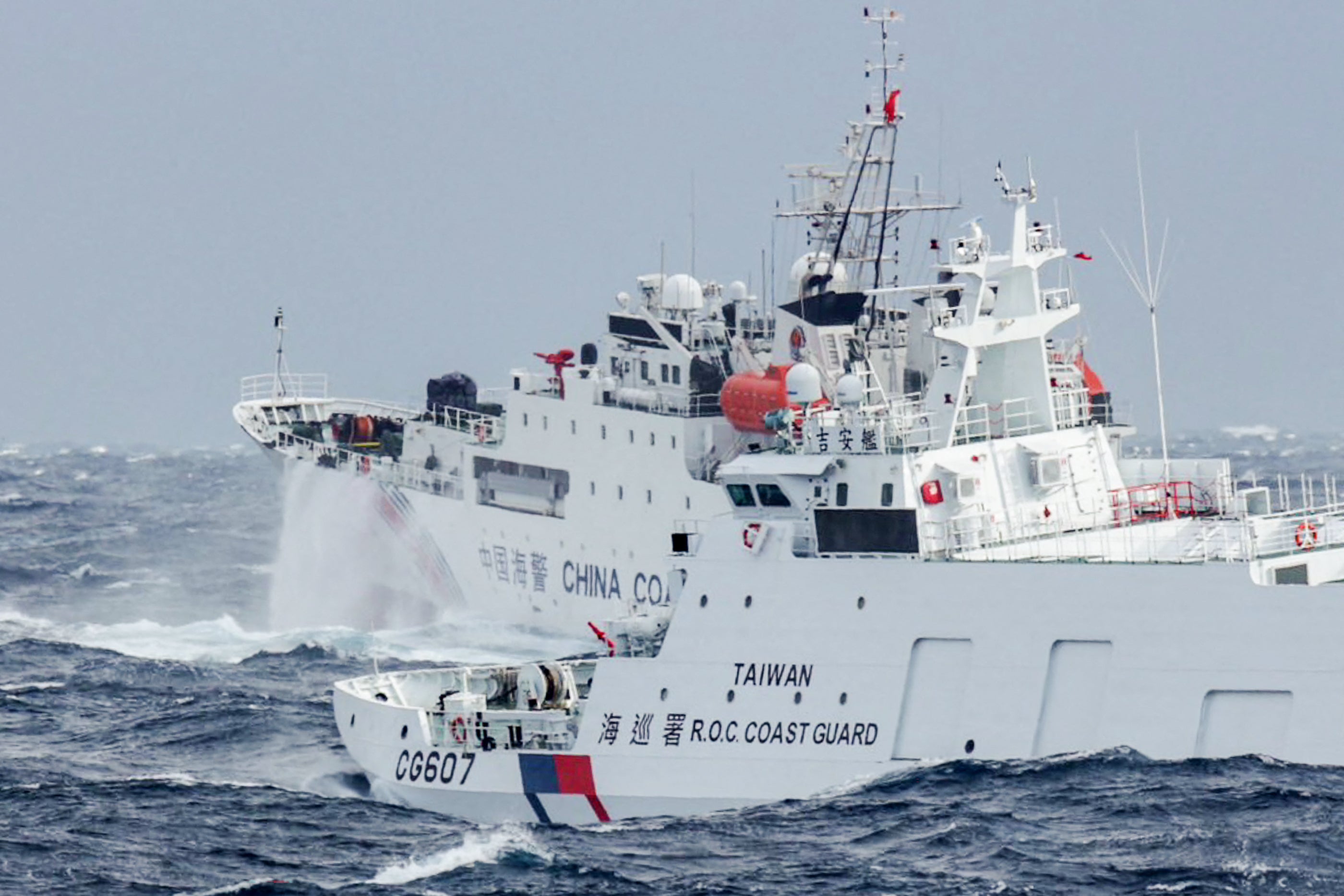 A Taiwanese coast guard ship monitors a Chinese military vessel near Taiwan