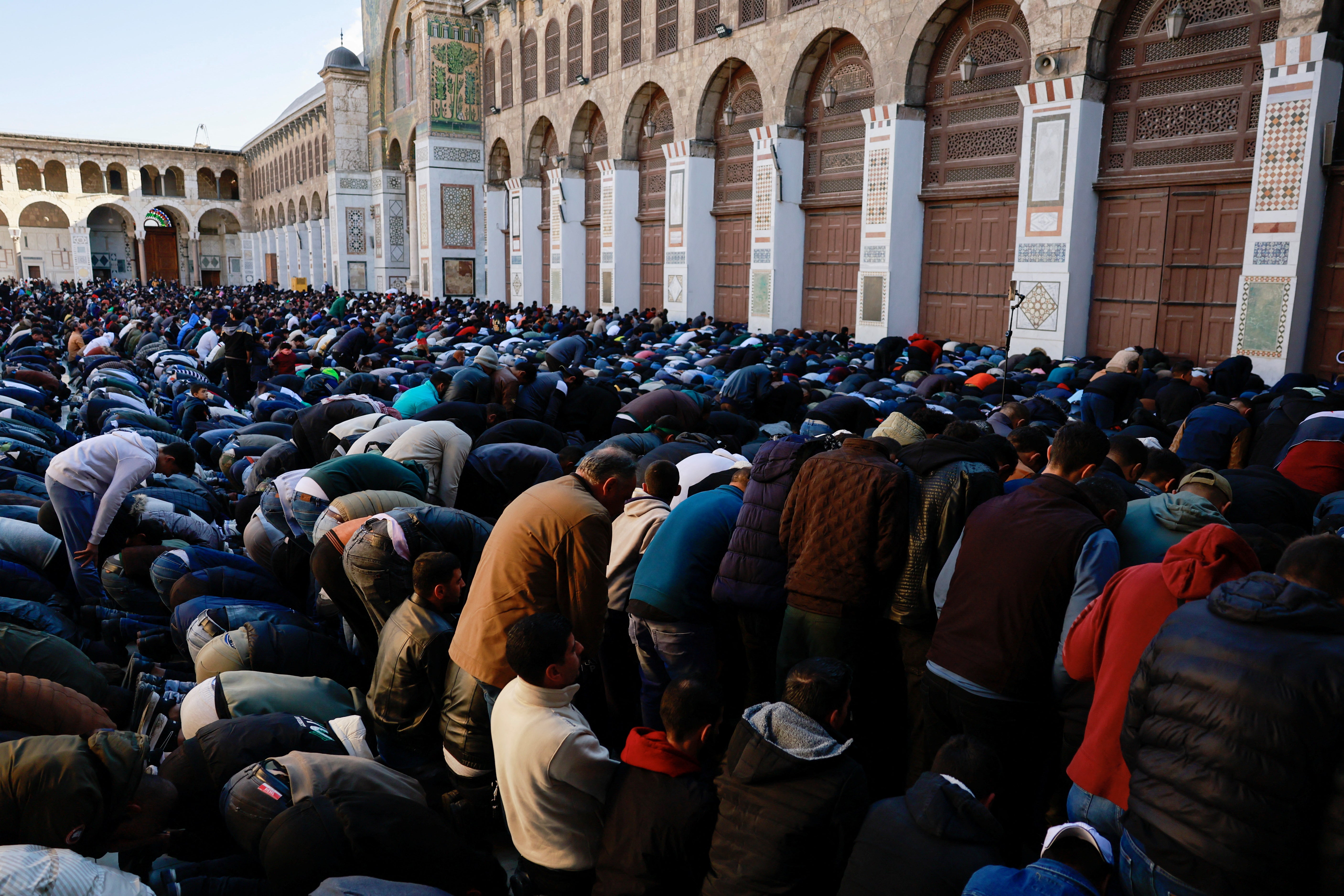 People attend the first Friday prayers inside the Umayyad Mosque