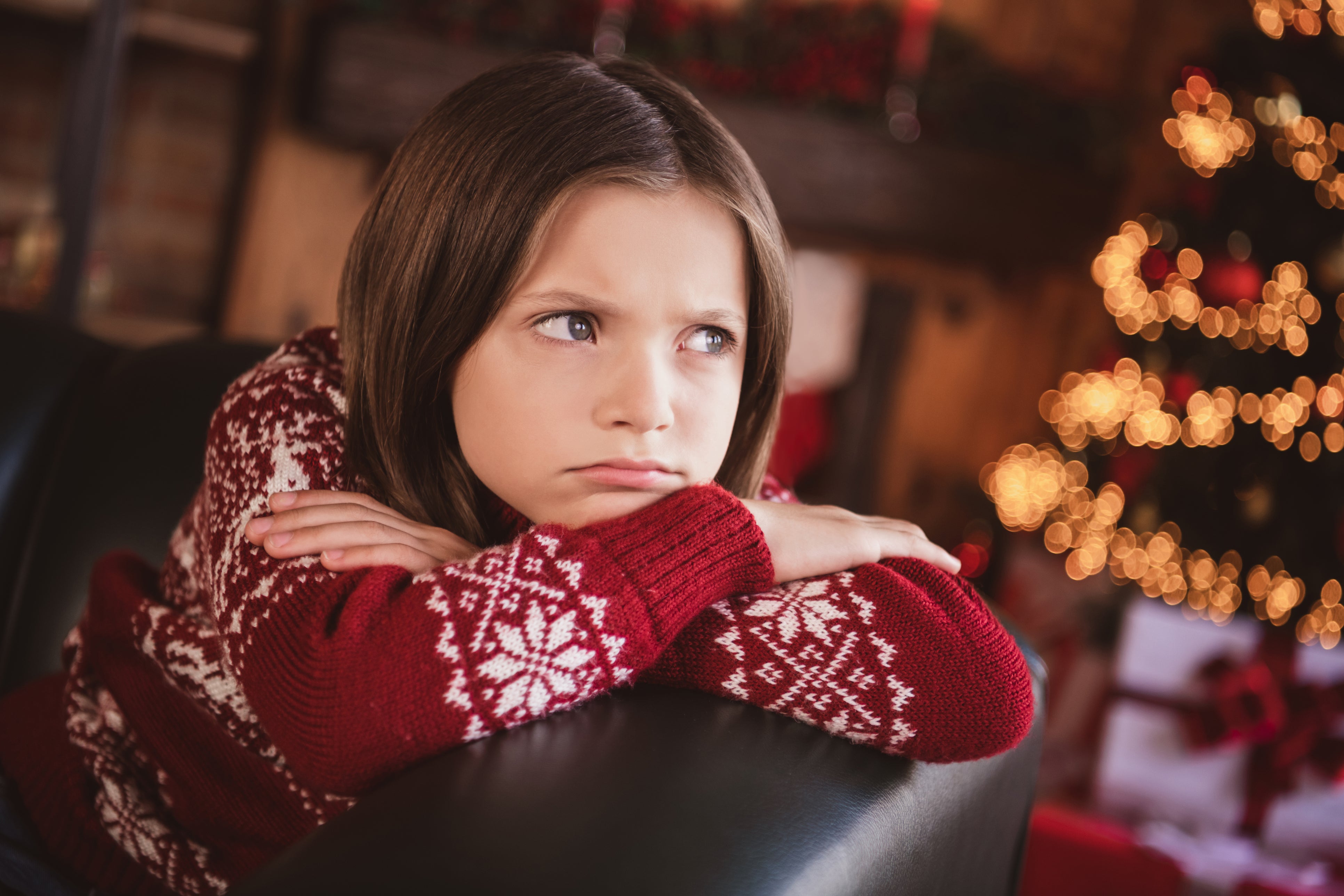 A young girl is upset at Christmas. A new poll reports that a quarter of American parents use Christmas-related threats to discipline their children when they misbehave