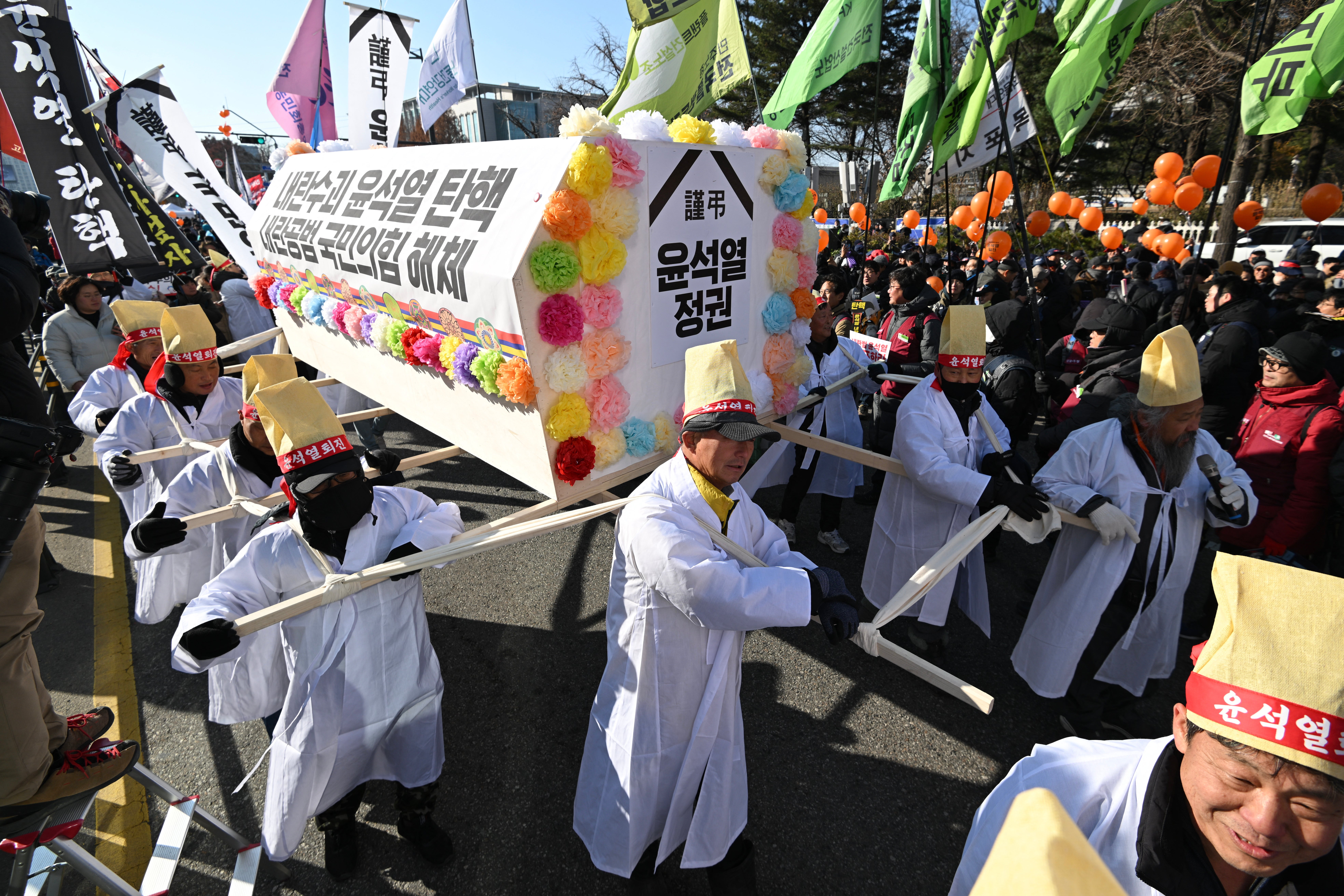 People carrying a coffin symbolising South Korea’s president Yoon Suk Yeol take part in a protest calling for Mr Yoon’s ouster