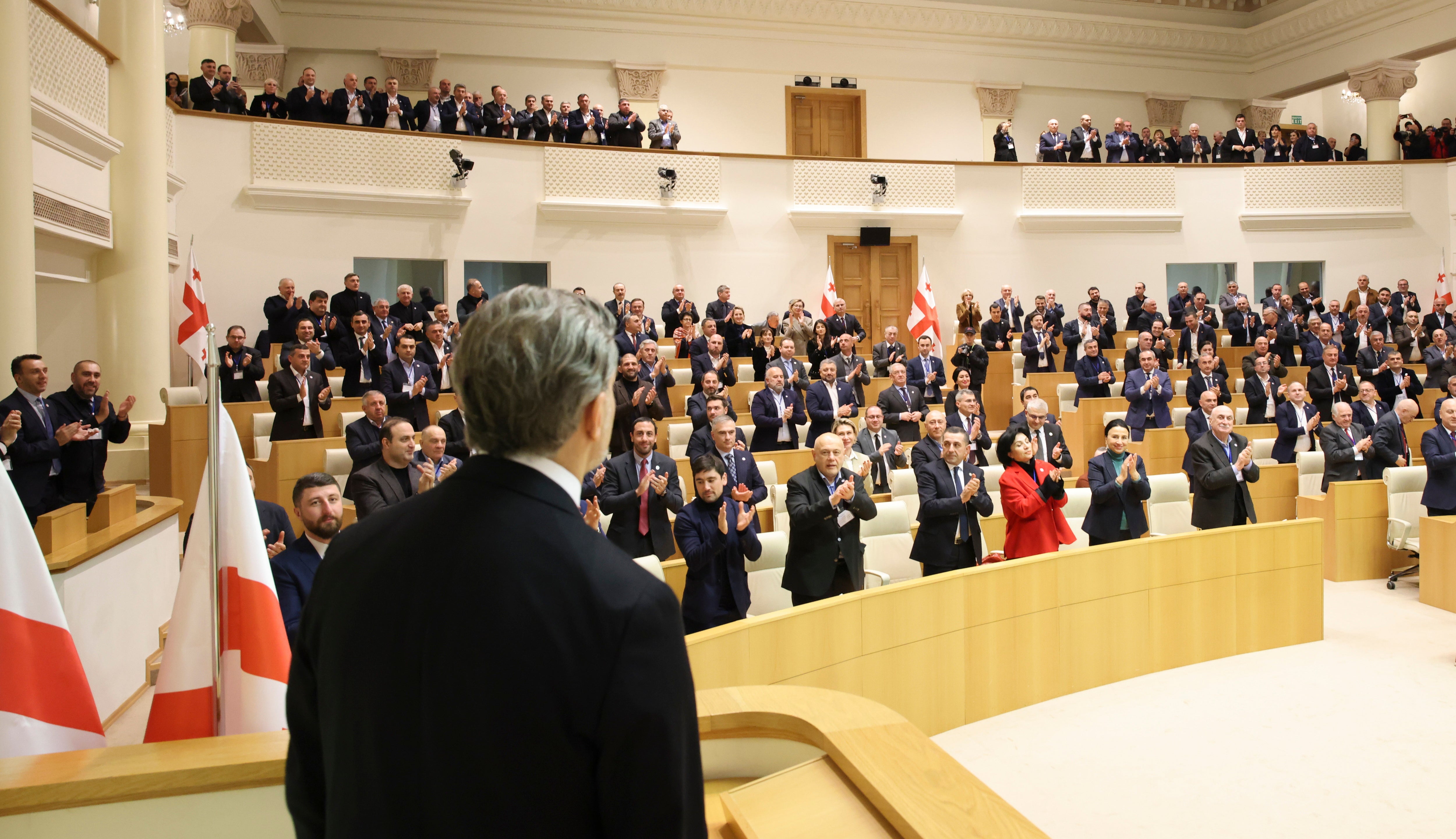 Mikheil Kavelashvili (L), only presidential candidate nominated by the ruling ‘Georgian Dream’ party, listens to applause after being selected as new Georgia’s president