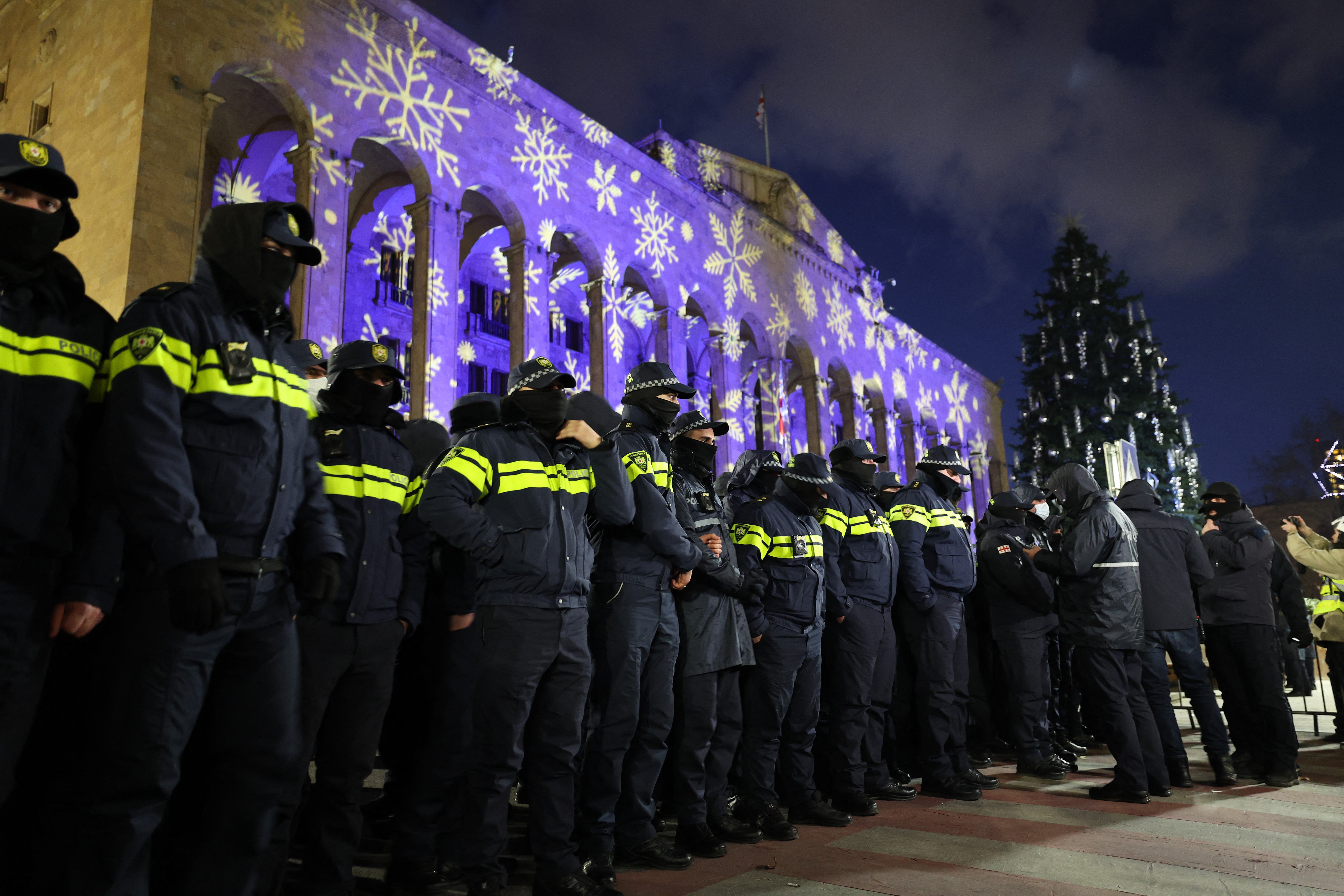 Police officers block the Georgian Parliament building as anti-government demonstrators gather outside the parliament in Tbilisi