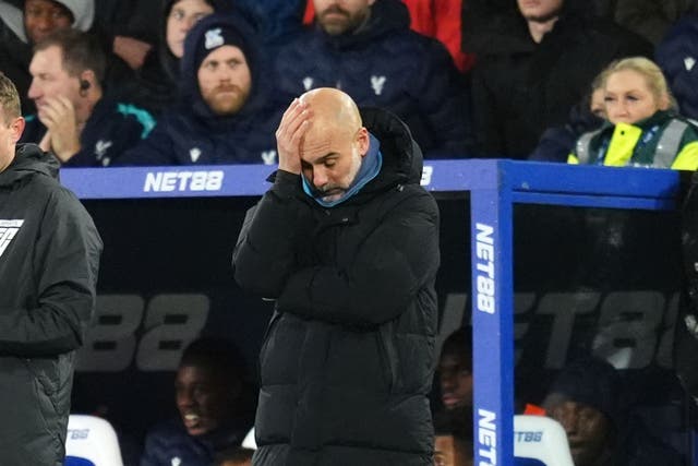 Manchester City manager Pep Guardiola holds his head in his hand (Adam Davy/PA)